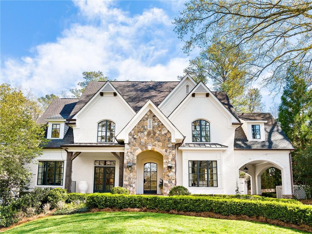 From the moment you step through the front door, the seamless flow of this home commands your attention. The elegant entertaining space of the formal Living and Dining rooms with custom millwork and crown molding set a sophisticated tone. Continuing through the front of the home, a chic powder room and exquisite designer office connect to another dedicated work/play space. The Great Room, adorned with glass and steel doors that accentuate the incredible natural light in the home, overlooks the landscaped backyard featuring a saltwater pool and gracious lawn, covered porch with wood burning fireplace, and generous space for relaxation. A family’s dream kitchen, boasting state-of-the-art appliances, wet bar, and eat-in dining nook combines effortlessly with the outdoor living area and Great Room. A large walk-in pantry adds to the kitchen's allure. Completing the main floor is a mudroom with ample storage, a convenient half bath - perfect for pool go-ers, and two-car garage.
The light filled staircase leads you to four bedrooms, each with an ensuite bath and closet featuring custom shelving. An adjacent laundry room with a sink and extra storage enhances the upper level's functionality. The primary suite features a gas fireplace, dual closets, double vanities, a double shower, a water closet, and an expansive linen closet. Over the garage, accessed by a private interior stair, is the perfect space for an additional bedroom or a handsome office with an attached full bath. No detail was overlooked on the terrace level, replete with recreational space, a bar area, a gym with mirrored walls, and an additional bedroom with a full bathroom. A striking cedar wine cellar and a multifunctional room, currently utilized as a golf simulator room, add a touch of luxury. There is also abundant storage on this level. Nestled on one of Buckhead's premier streets, this home is ideally located near Atlanta's finest schools, shopping destinations, restaurants, and more. Indulge in the epitome of sophisticated living at this exclusive address.