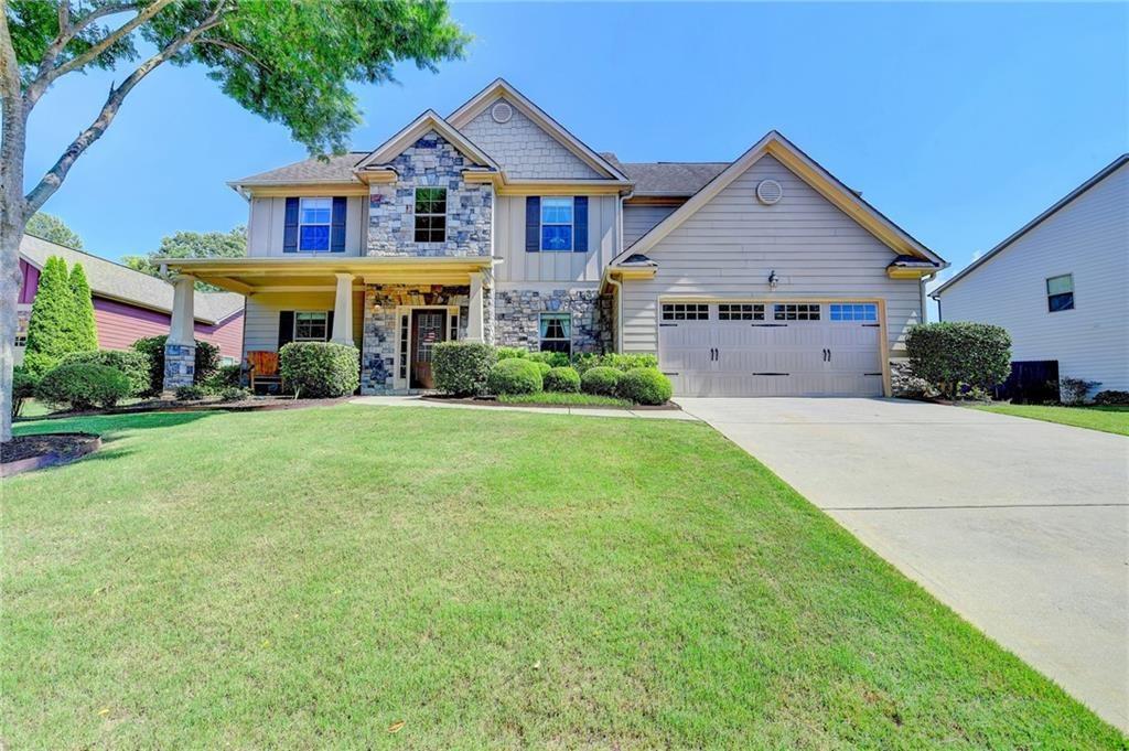 Have you been holding out for a home that blends charm, function, and that little bit of something special? Welcome to 3975 Silverthorn Trace—located in the desirable Hunters Walk community and zoned for award-winning schools, this 5-bedroom, 3-bathroom home checks all the hard to find boxes. From the start, the stone façade and rocking chair front porch create an inviting first impression. Step inside to a two-story foyer flanked by a large dining room with coffered ceilings and a versatile flex room—ideal as an office, playroom, or formal sitting space. The main floor also includes a guest bedroom and full bath for added convenience. The kitchen and living area were designed with everyday life in mind—offering a comfortable, open layout perfect for both entertaining and relaxing. You’ll find neutral granite countertops, upgraded 42-inch cabinetry, a center island, and a breakfast area that flows into a cozy family room with a fireplace. Just off the kitchen, step onto one of the home's standout features: the covered and screened-in porch overlooking the flat, sodded, and fenced backyard. It's a perfect spot for dining outside, watching the game, or winding down under the soft glow of string lights while the kids or pets play within view. Upstairs, the oversized primary suite includes a peaceful sitting area, an expansive bathroom with dual vanities, an extra-large shower and soaking tub, and a walk-in closet you’ll love. You'll also find three additional well-sized bedrooms, and the upstairs laundry room is right where you need it—just outside the primary suite. Throughout the home, arched doorways add character and a level of craftsmanship rarely found in today’s new construction. Across the street, a wooded HOA-owned greenspace ensures lasting privacy and a tranquil view from the front porch. Set on a quiet double cul-de-sac street in a neighborhood known for its sense of pride and community, Hunters Walk offers trails, a pool, lighted tennis courts, sidewalks throughout, and a playground. This part of Cumming strikes a rare balance—it feels tucked away and peaceful, yet you’re never far from everyday conveniences or community events. With exciting new commercial development and investment happening nearby, it’s easy to see that this is not only a wonderful place to live now, but a smart place to invest in for the future. All within great proximity to the Big Creek Greenway, The Cumming City Center, charming Downtown Cumming, and top-tier dining and shopping. Come see this home for yourself—you’ll be glad you did.