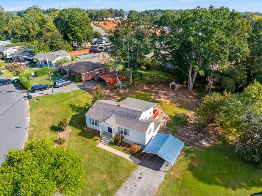 Welcome Home! This charming 2-bedroom ranch offers a bonus room and 1 full bath on a spacious lot in a quiet subdivision of East Cobb. Recently updated with fresh paint, new flooring, granite counters, and modern appliances, this home is move-in ready. Inside, you'll find a separate dining room, a cozy family room, and a flexible bonus/office space. The laundry room is conveniently located near the kitchen, and washer/dryer are included. Relax on the screened-in porch or enjoy the fenced backyard, perfect for kids and pets. A storage shed provides extra space for tools or hobbies. Parking includes a 2-car carport and driveway. Located on a large corner lot in a quiet subdivision, this home is located in a prime location close to shopping, dining,Truist Park, Marietta Square, and with quick access to I-75. No HOA.