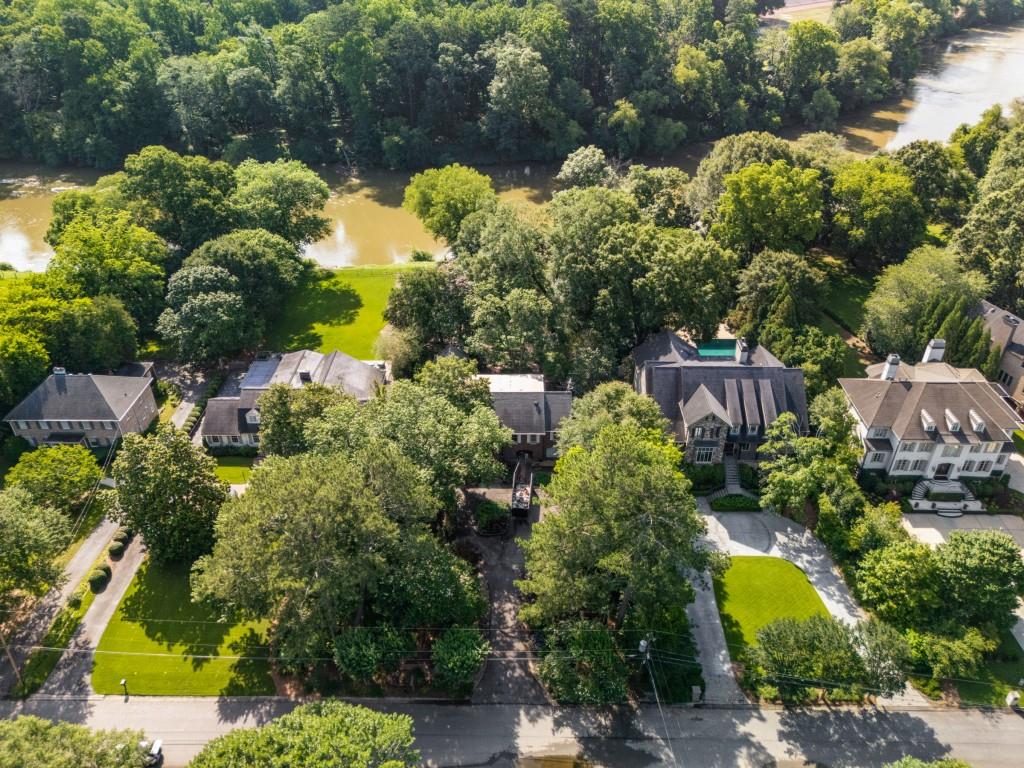 Exceptional 1-acre lot on the Chattahoochee River along prestigious Cochise Drive. First time available in nearly 50 years! Originally a ranch, the home was elevated in 2010 on an engineered, approved foundation above the 100-year floodplain ready for a custom rebuild. Utilize the existing poured concrete foundation for a stunning "beach house" style residence with a 4-car garage below, or keep brick structure and "pop the top". Enjoy a large building footprint, panoramic river views, and proximity to top-rated schools, Buckhead, the Battery, easy access to highways and Vinings Jubilee Shops. Low Cobb county taxes currently reflected with senior discount. Ideal for experienced builders familiar with Cobb County and ARC. Survey, as-is architectural plans, and engineering documents are available.