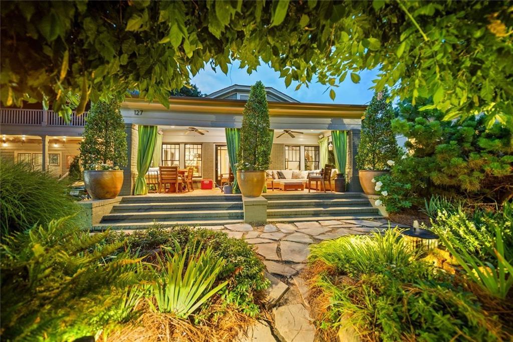 Tucked away on one of Oakhurst’s rare cul-de-sacs, this beautifully renovated 3BR/2BA brick home blends thoughtful design, modern comfort, and smart sustainability. The reimagined floor plan opens the kitchen and dining area for seamless entertaining, featuring a gas cooktop, beverage fridge, and abundant storage—including a walk-in pantry/laundry room.
The expanded primary suite serves as a private retreat with a spacious walk-in closet, separate shower, and soaking tub. Designed with entertaining in mind, enjoy an inviting front porch, rear screened porch, and a large stone terrace with a built-in firepit.
Additional upgrades include solar panels, on-demand water heater, and added insulation—helping to significantly offset utility costs year-round. A large rear storage building adds function, while professionally curated gardens offer privacy, seasonal interest, and two tranquil water features. Cafe lights add evening ambiance for unforgettable outdoor gatherings.
Ideally located just a short walk to Oakhurst Village, 2nd Ave Village, and all neighborhood schools. The cul-de-sac is a tight-knit community that even hosts bands each fall for the beloved 'PorchFest.' This home is truly special—but the street is where you’ll want to put down roots.