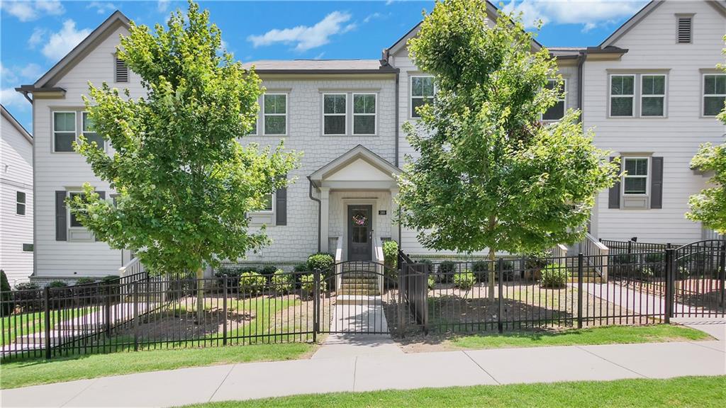 Welcome home to this stunning three-story townhome in the heart of Towne Lake complete with a fenced in front yard. This open-concept
floorplan offers 3 bedrooms, 3.5 bathrooms and a spacious family room with a fireplace. The family room seamlessly flows into a sleek,
modern kitchen featuring 42" white cabinets, quartz countertops, stainless steel appliances, a large island and a pantry. From the family
room, step outside onto the expansive deck, perfect for entertaining or relaxing. On the upper level you will find the primary suite with a
generous walk-in closet, a beautifully tiled shower and two additional bedrooms. The terrace level has a bonus room with a full bathroom
that could be used as a media room or a home office. Nestled in the highly sought-after Woodstock school district, this townhome is within
walking distance to Greenprints Trail and conveniently located to dining, shopping, entertainment and has easy access to I-575. Don’t miss
your chance to make this beautiful townhome yours.