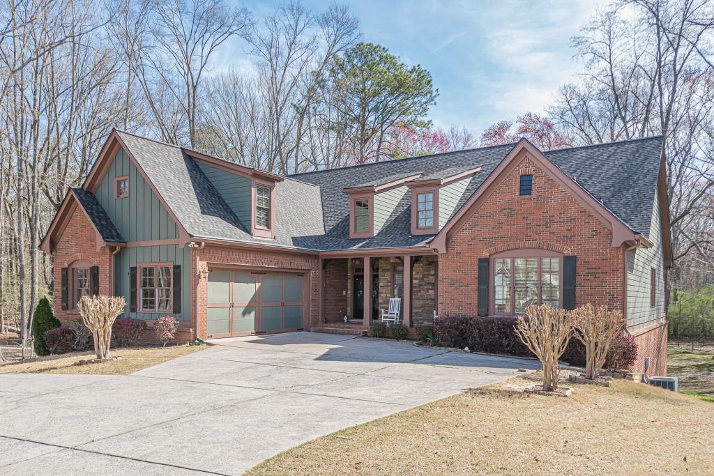 Welcome to this custom-built gem nestled on the largest lot in the subdivision, offering space, privacy, and endless possibilities! Located in a top-rated school district, this stunning home boasts exceptional craftsmanship and thoughtful details throughout. Step inside to find hardwood floors throughout the main level, leading to a spacious primary suite with a luxurious ensuite bathroom. The huge kitchen is a chef' s dream, featuring custom cabinetry, stainless steel appliances, and a bright breakfast area. The large secondary bedrooms provide ample space for family and guests, including a perfect guest suite/bonus room upstairs with its own private ensuite bathroom. The finished basement is a true retreat, complete with a private bedroom, full bathroom, and game room. A dedicated workshop in the basement offers the opportunity to be finished for additional living space. Enjoy the outdoors from the enclosed porch or the expanded deck, both overlooking the beautiful private backyard ideal for relaxation or entertaining. The extended driveway offers additional parking space, accommodating multiple cars, and even includes a carport big enough for an RV. Home also includes a BRAND NEW ROOF!!! For those who love to create and grow, this property also features a large workshop and a dedicated garden setup for anyone with a green thumb. With custom features throughout and endless possibilities, this incredible home is ready for its next owner. Don't miss out schedule your private tour today!