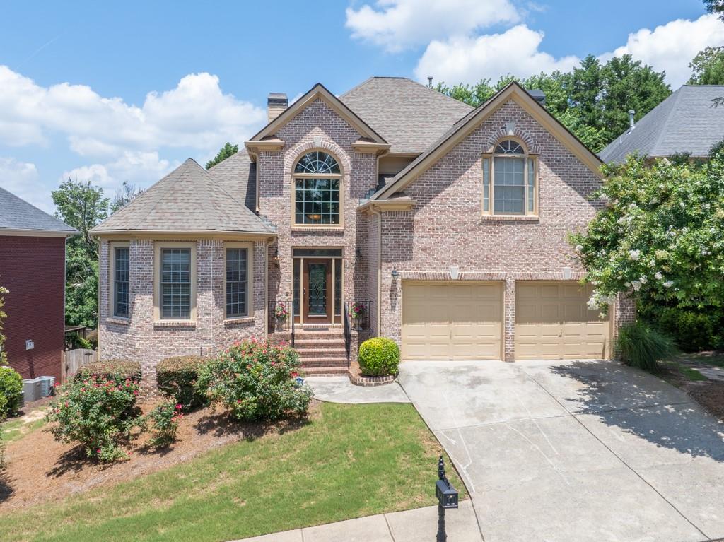 Welcome to this great home lovingly maintained by it's owners for over 23 years. The beautiful knock out roses, pink hibiscus and crepe myrtles cannot wait to greet you as you step inside the grand foyer of this home. To your left is the formal sitting room or office with double doors, to the right a half bath and coat closet. Step further inside and to the left is the oversized primary suite on main with double closets and a large primary bath with double vanities, large tub and separate shower. Take a seat in the family room and view the large TV (this will stay) over the great fireplace with large floor to ceiling bookcases. To the right of the home is the formal dining that seats 12 across from the kitchen. Many of the stainless steel appliances are new within the past few years and loads of oak cabinets and plenty of counter space. A island perfect for sitting completes the kitchen area. Just off the kitchen you will find a deck that overlooks the lush backyard. Upstairs you will find three spacious bedrooms with one jack and jill bathroom and one bedroom with it's own bath and a loft area. All of this sits on a huge full unfinished basement just waiting on your updates. The owner has maintained and has been working on getting things ready for the new buyers, so many great things about this home that await your updates and creativity. The community features a swimming pool and active home owners association and is the most convenient of locations to easily get to downtown Atlanta, Smyrna, Vinings, community parks, greenspaces, restaurants and entertainment galore.