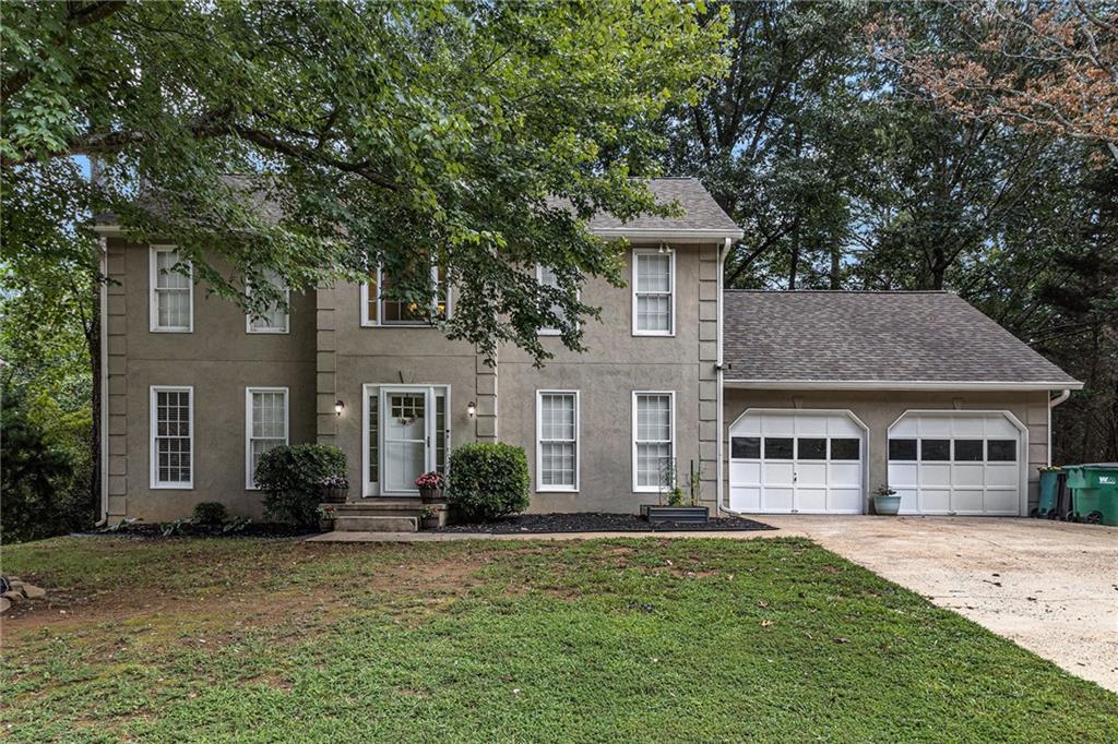 Welcome to this beautifully maintained two-story traditional home located in the highly sought-after Woodstock High School District in Cherokee County. Perfectly situated with convenient access to I-575, I-75, Downtown Woodstock, Town Center shopping, and KSU, this home offers both comfort and convenience. Nestled on a private, wooded lot, the property features a durable hardcoat stucco exterior with HardiPlank siding and a brand-new back deck overlooking the serene backyard. Inside, you’ll find updated paint and flooring throughout, creating a fresh, modern aesthetic. The main level offers multiple living spaces, including a formal dining room and a versatile flex room—ideal for a home office, playroom, or additional sitting area. The spacious eat-in kitchen features white cabinetry, stone countertops, and easy access to the main-level laundry room. The cozy family room includes a fireplace for warm, inviting gatherings. Upstairs, you’ll find three generously sized bedrooms and two full baths. The oversized owner’s suite is a private retreat with a whirlpool soaking tub, separate shower, dual walk-in closets, and abundant natural light. The full, unfinished basement with high ceilings offers endless potential for storage, recreation, or future finished space to suit your needs. Additional highlights include a two-car garage and an extended driveway for ample guest parking. Located in a neighborhood with an optional HOA for pool access, this property combines flexibility and lifestyle. Priced to sell—schedule your private showing today!