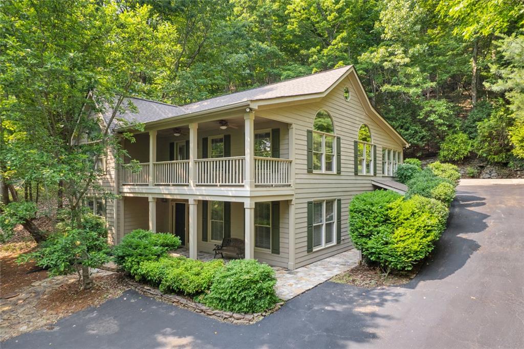 Not Your Typical Big Canoe Home – Unique, Inviting & Full of Character This quality-crafted home was thoughtfully built by a builder for his own family. He enjoyed adding unique touches to every home he designed. With this one, he set out to bring the outdoors in. Featuring 4044sf 3 bedrooms, 2 full baths, 2 half baths, a bunk room, office, and multiple flex spaces, this home offers room for everyone and everything. The main level welcomes you with a spacious kitchen with pantry, breakfast nook, built-in desk, and a pass-through to the formal dining room. A light-filled sunroom, inviting living room with a unique and charming shingle roofline, and flowing layout make this home ideal for both relaxing and entertaining. The primary suite includes a sitting room w/ bookcase, his & her bathrooms, a large walk-in closet w/ his & her sides that is connected to the laundry room, and a back staircase leading to the bonus room, bunk room, flex space, half bath and attic storage. The terrace level offers a foyer entry, two large bedrooms with high ceilings & tall windows, a full bath, an office, and a huge multipurpose room, ideal for billiards, media, or recreation. There is also an unfinished storage area perfect for a workshop or storage. This special home has been freshly painted the perfect neutral color for move-in readiness. New carpet and hardwood flooring for the terrace level and the carpet on upper level has been professionally cleaned. Step outside and enjoy the stone front porch, a covered deck off the living room, and an open rear deck, perfect for listening to the sights and sounds of nature overlooking the nearby natural spring waterfall framed by lush greenery. Ample guest parking makes it easy to share the experience with friends and family. Tucked away in a quiet, private section of Big Canoe, you're just minutes from Indian Rocks Park and nature trails. This is a home with soul, space, and scenery. Bring your creativity, it’s ready for you to make it your own!
*Buyer to verify all information deemed important.