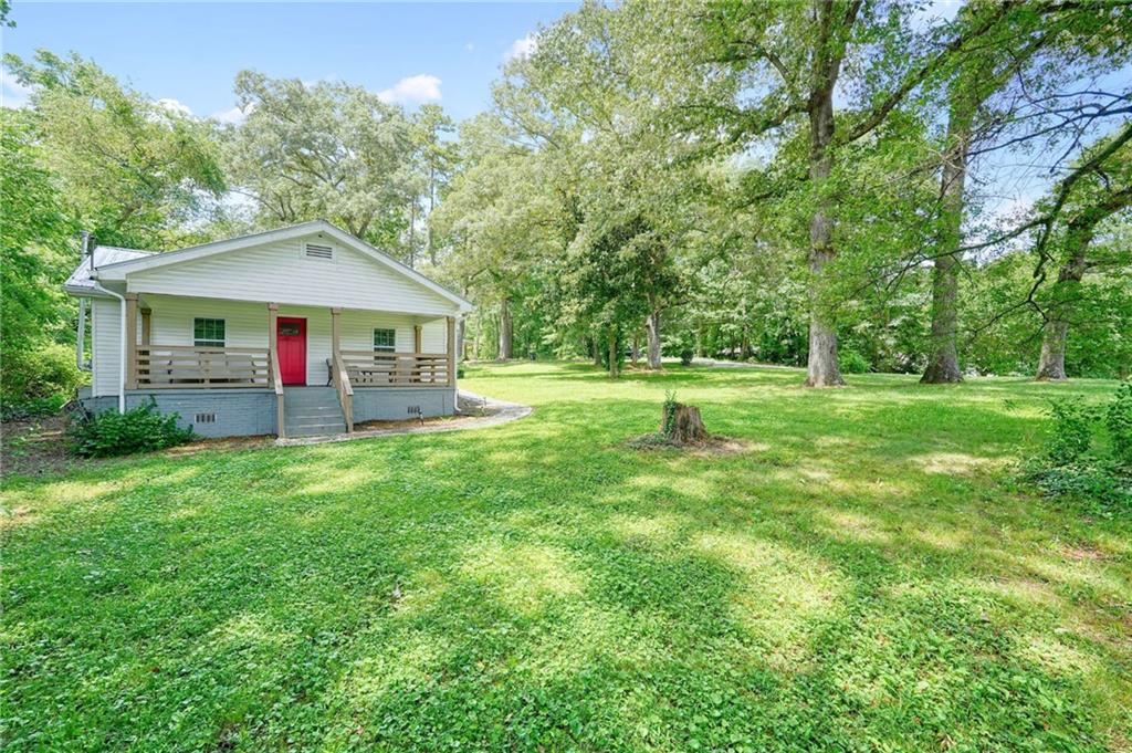 Fully renovated in 2022, this 3 bedroom, 2 bath home sits on over a half acre lot in a peaceful rural setting just minutes from downtown Ball Ground and Canton. The interior is complete with modern touches featuring a spacious chef’s kitchen with a large island, quartz countertops, white shaker cabinets, and stainless steel appliances. The primary bedroom includes a private en-suite bath, while two additional bedrooms share an updated full bathroom. A dedicated laundry room is located just off the kitchen. Upgrades go beyond just cosmetics and include updated HVAC, windows, plumbing, lighting, and a durable metal roof for long-term peace of mind. Outdoors, enjoy a large covered front porch, spacious yard, firepit area, and plenty of room for gardening, pets, or play. The wide, level lot offers space to add a garage, workshop, or expand outdoor living areas. Tucked away in a quiet setting, yet just minutes to I-575 with easy access to both Atlanta and North Georgia, this home offers the perfect balance of privacy and convenience. Furnishings negotiable. Added Bonus: Take advantage of the two neighboring homes also available for sale and create the ultimate family compound!