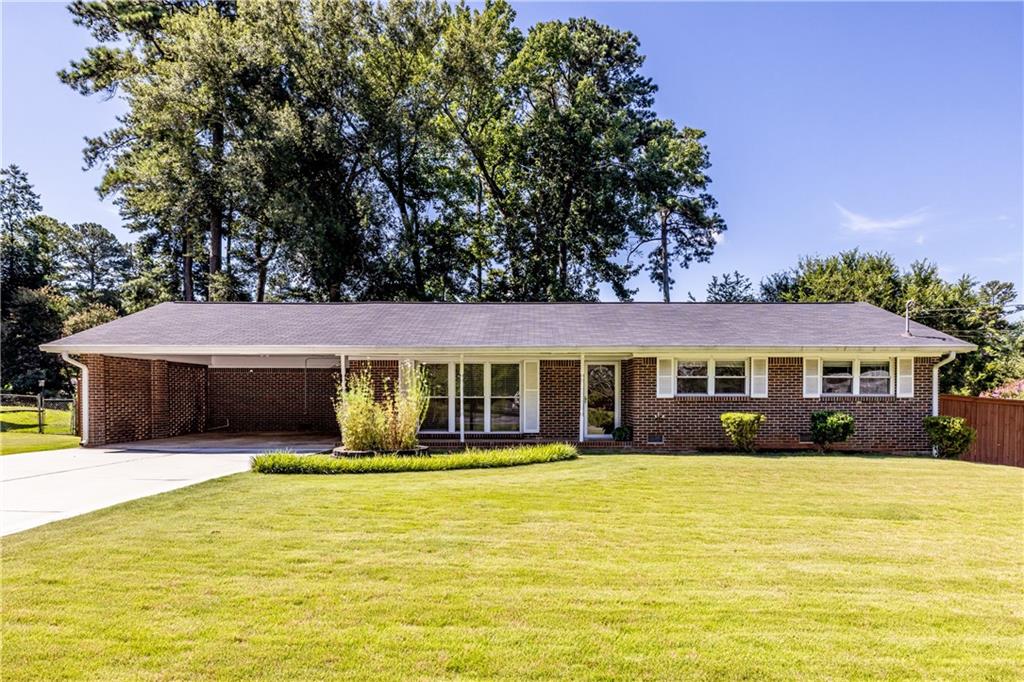 Welcome home to this charming 4-sided brick ranch on a beautiful .4-acre, sun-filled level lot in Tucker. Ideal for garden enthusiasts or woodworking hobbyists, this property features established raised garden beds, a greenhouse, a powered and lit workshop, plus a large storage shed. There is plenty of space for play, pets, and additional landscaping. A covered patio provides a great spot for outdoor dining and relaxing year-round. Inside, you will find newly refinished hardwood floors and fresh interior paint throughout, offering a clean slate to move right in and update at your own pace. Additional improvements include a new driveway, roof and gutters (2020), HVAC (2021), water heater and interior plumbing lines (2019), plus energy-efficient double-pane windows. Located just minutes from Tucker’s vibrant Main Street with local shops, restaurants, and popular community farmers market. This well loved home offers a wonderful opportunity for anyone looking for low maintenance, one level living at an affordable price.