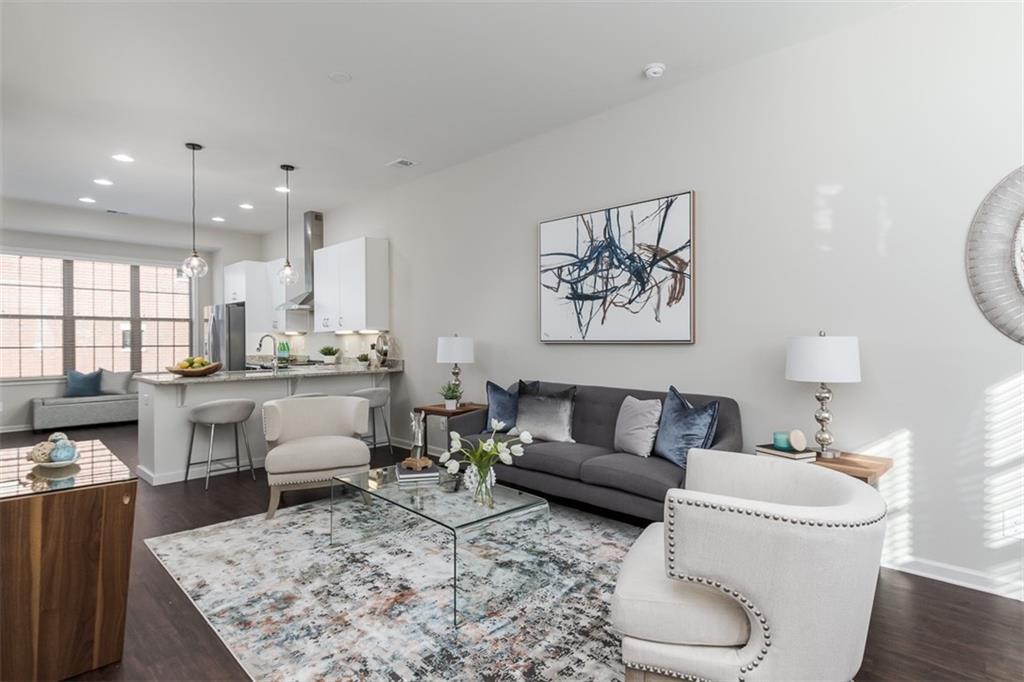 Meticulously maintained 2bedroom/2.5bath contemporary townhouse in HIGHLY sought-after Buckhead location with access right outside your front door to Path400 and the Beltline, Marta, Phipps and Lenox Mall, and tons of restaurants/entertainment in Midtown and Buckhead. Sleek open concept living with upgrades galore featuring 10+ ceilings on the main level, hardwood floors, tons of natural light, designer lighting, and lush interior finishes. Top-of-the-line chef's kitchen with custom white cabinetry, granite countertops, SS appliances with vent hood, and breakfast bar opening to oversized living room/dining room. Roommate floor plan with spacious owner's and secondary room upstairs. Spa like owner's bath with upgraded stand up shower and marble counters. Office/bonus room on first floor opening to private 1 car garage. Built 3 years ago and looks and feels brand new! Wonderful live, work, play community centrally located to EVERYTHING!