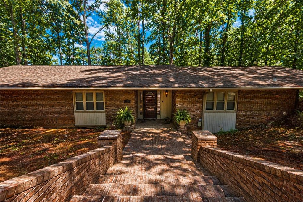 Brick exterior home with a gabled roofline