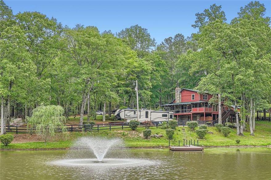 Stunning Lakefront Retreat on 6+ Acres – Private, Peaceful & Just Minutes from the City
Welcome to your dream escape! This exceptional lakefront property offers over 6 acres of serene, scenic beauty—perfectly blending the charm of country living with the convenience of modern amenities. Located just 5 miles from I-20 and a short 22 mile drive to downtown Atlanta, you’ll enjoy peaceful seclusion without sacrificing accessibility.
As you arrive, you’re greeted by circular drives, ample paved parking, and a wraparound porch that invites you to relax and take in the views. Whether you're entertaining guests, soaking in the jacuzzi hot tub, or just enjoying a quiet morning coffee, this home has it all.
Inside, the two-story great room impresses with soaring ceilings, an abundance of natural light, and expansive views of the property’s private, spring-fed lake—complete with fountain and dock. The open-concept layout flows effortlessly into the updated kitchen featuring granite countertops, modern appliances, and generous cabinetry, making everyday living and entertaining a breeze.
A spacious loft overlooks the main living area and provides the perfect flex space for a home office, reading nook, or guest retreat. The home includes 4 well-sized bedrooms and 2.5 updated baths, with a finished basement offering even more living space—ideal for a media room, gym, playroom, or additional bedroom.
Outdoor enthusiasts and hobby farmers will love the large garage/workshop, storage shed, and functional chicken coops already in place. The property is dotted with mature trees, flowering landscaping, and fenced areas ready for pets, livestock, or gardening.
Enjoy life by the lake—fish off your private dock, host a sunset gathering, or simply take in the peaceful surroundings. With top-rated schools nearby and quick access to major roads, this is the perfect place to unwind, grow, and make memories.
All that’s missing is you. Schedule your private tour today and experience the magic of this one-of-a-kind lakefront retreat!