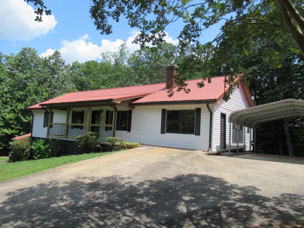 Fall in love with this completely remodeled charming home. The main living area comes with 3 bedrooms and 2 full baths. The primary bath offer seperate garden tub & rain showe while the second bath has double vanity, & rain shower. Great room has cathedral ceiling with fireplace gas log for large gatherings or cozy up in the sunroom. Laundry room is spaciou and is a walk in pantry. Kitchen pops with the granite counter tops and stainless steel appliances while enjoying the eat in bar. All new plumbing, electrical, paint, lighting, doors, flooring and siding like having a new house. The finished basement can be an excellent in law suite or income producing rental apartment. It has a full kitchen, laundry area, dining area, living area, large bedroom and full private bath. Wonderful private side porch to enjoy. Private interior and exterior entrance and driveway. Great opportunity with combination of size, acreage and proximity to downtown Dahlonega. Tucked away in the corner gives privacy on this 2+ acre lot but yet minutes to downtown Dahlonega.