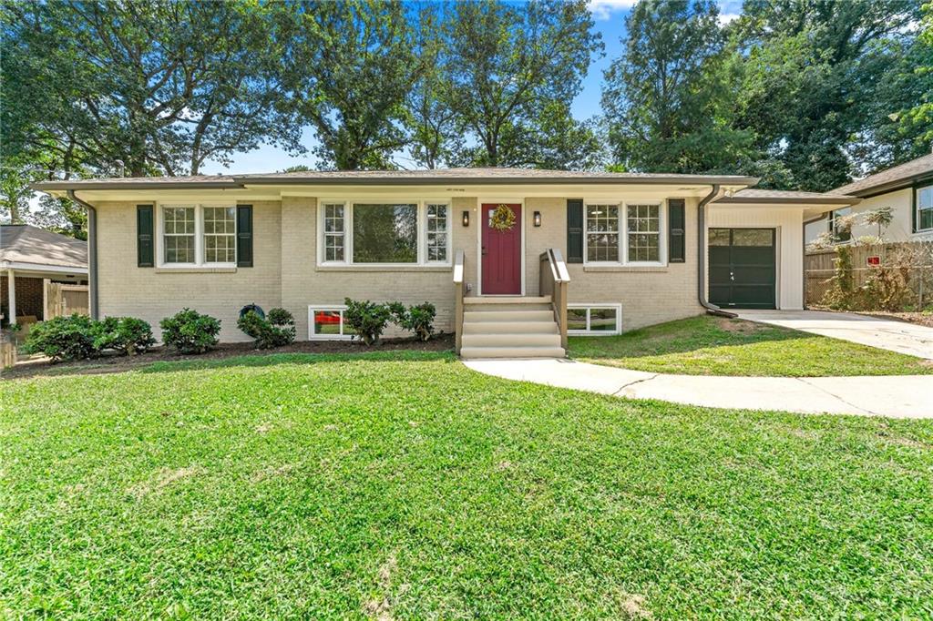 East Atlanta Beauty! Close to the action! Another total remodel from TrueWay Properties! This property has 3 bedrooms 2 baths with a possible bedroom in basement. Bonus room with living room area and private ground level entrance. Come see this one and have your friends over to hang on the private oversize patio. The garage offers unique drive through to the back yard with expanded area for entertaining. The inside has been completely updated with all new LED lighting and fashionable fixtures to give it a designer look and feel. Beautiful new tile accents and quartzite counter tops. You will be proud to own this home in a highly desirable area close to restaurants and night life of East Atlanta! The home is very comfortable and has all the nicer kitchen appliances by Bosch and kitchen aid with seperate oven and cooktop. Front picture window sitting high on the lot. Come visit this home and see if it is the one for you!