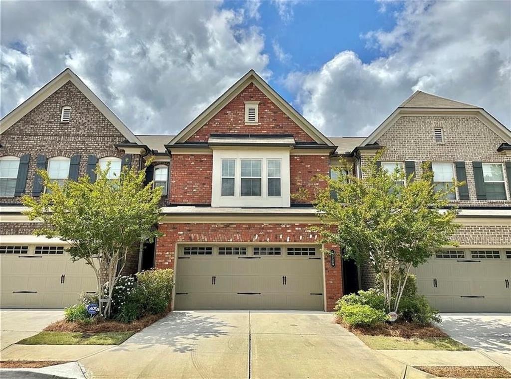 Welcome to this beautiful 3-bed, 2.5-bath brick-front townhome in the sought-after Amberly Mill community of Lawrenceville. Offering 1,830 sq ft of comfortable living space, this home features an open main level with hardwood floors, a cozy fireplace, and a modern kitchen with granite countertops, stainless steel appliances, a large island, and walk-in pantry. Upstairs, the spacious primary suite includes a soaking tub, separate shower, dual vanities, and a walk-in closet, while two additional bedrooms, a full bath, and laundry with washer and dryer add convenience. Enjoy a private patio with wooded views plus the ease of an attached garage and HOA-maintained landscaping. Ideally located near I-85, Sugarloaf Mills, dining, parks, and downtown Lawrenceville, this move-in ready home offers both style and convenience.
