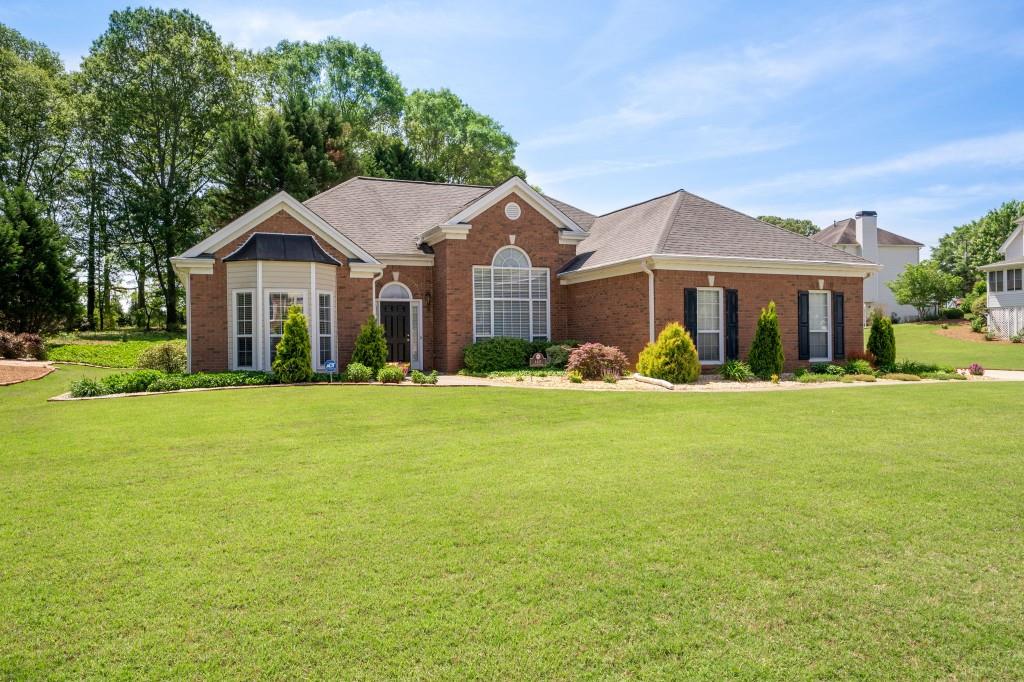 The Perfect Stepless Brick Front Ranch you have been waiting for! Freshly painted and well maintained by the original owner. Open floorplan with a formal living room with bay window that makes a great home office. Large Family Room features a Fireplace surrounded by windows. You will love the airy feeling as the home gets plenty of light from all the windows. Split bedroom plan with a spacious master suite with a tray ceiling and a huge walk-in closet. The master bath is large with double vanities and a separate tub and shower. The secondary bedrooms are both spacious with nice sized closets and share an updated bath. The Kitchen is open to the Breakfast Room and Family Room and features updated LPV flooring, newer Stainless Appliances and a Walk-In Pantry. Convenient roomy Laundry Room just off garage entry. The owner has added beautiful landscaping with a Japanese Maple and lots of beautiful plants. The lot is very level and private and features an irrigation system in both front and back yards and is sodded both front and back. Enjoy nature from the private patio. Perfect little shed for all your outdoor tools is included. Level driveway with side entry two car garage. Quite neighborhood in desirable West Cobb Hillgrove High district. Just minutes from the Avenues and shopping but you will feel like you are in the country.
