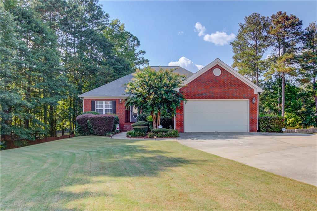 Welcome to your entertainer's dream home and your own private retreat! This brick-front home is situated on about two-thirds of an acre that backs up to a beautiful pond. The pond is fronted by only 7 properties and is stocked with bass for great fishing! The main floor offers a split bedroom floorplan with the primary bedroom on one side and two bedrooms and a bath on the other. The living room has trey ceilings, a fireplace, and a built-in speaker system that extends into the kitchen, primary bedroom and back porch. The kitchen includes an island with an eat-at bar, a breakfast nook and an additional fireplace. The primary bedroom includes trey ceilings with his and her closets, a double vanity and a separate shower and tub. Off of the living room, you can walk out to your screened in deck with stairs leading down to a 50ft x 60ft deck that surrounds your pool that is 33ft wide by 4 ft deep. The pool and deck were installed just last year. Travel downstairs to your fully finished basement that is perfect for entertaining or a completely separate living quarters. The basement includes a full kitchen, with granite countertops, separate laundry room, 2 bedrooms, an additional office that could be used as another bedroom, a large storage area, a tornado room, and a theater! This one won't last long!
