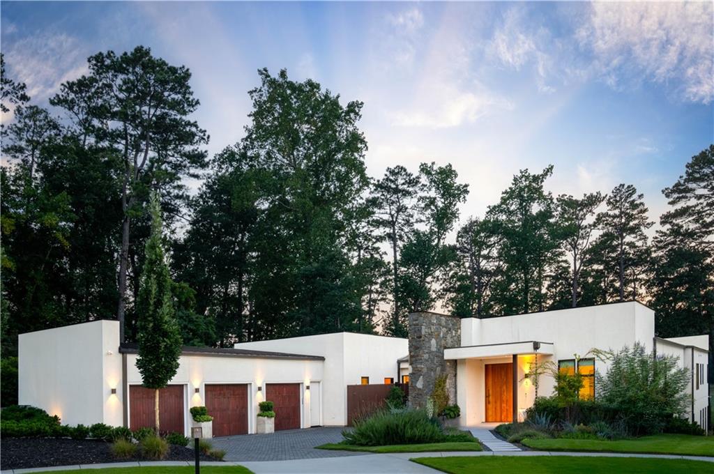 If there were levels of perfection for location, design, style , and utility, 1572 Clifton Ridge would be the perfection of the perfect. Literally a five minute walk to the Emory University campus , an epicenter of education and culture, this home is built of the finest materials available in the market. Paradise awaits a new owner with a truly unique and scarce combination of the best Atlanta has to offer.
This pristine home is sited in a private cul-de-sac atop a crest overlooking Druid Hills golf course, on a lusciously landscaped lot enveloping this structure.
Completed in 2022, this home has barely been lived in. It is still in “like new” condition. Current owner purchase in 2023 and has since then, made multiple improvements , including finishing the terrace level. The clean, contemporary design provides order to every aspect of the environment . The quality of the materials used to craft this home is evident the moment you step into its welcoming , warm embrace. Served by a whole home “Smart” Lutron system, the security system, lights ,HVAC, audio visual system and automatic window shades can all be controlled by cell phone or by voice activation within the home. From the moment you enter the custom wooden door, natural light fills every inch of this stylish open floor plan, an environment that produces order and calm. The automatic sliding doors in the living room open the kitchen and dining room to a walk-out pool, an oasis with a firepit and views of the golf course that will take your breath away from sun up to sun down. The kitchen provides the highest quality appliances available in the market , featuring double Gaggenau ovens and sleek , clean, convection cooktop. Separate and spacious refrigerator and freezer are disguised behind furniture quality wood work. A large scullery is hidden behind the wood panels, blending into a clean, sleek environment. A convenient yet private, window lined primary suite overlooks the pool and the golf course. The primary bathroom hosts an award-winning shower and stand-alone tub along with a closet fit for a clothes collector.
On the other side of the U-shaped home there are three large bedrooms, all with en-suite , large, luxurious bathrooms and closets. On the main level, supporting a calm and convenient lifestyle, there is a media den with built in projector and audio visual system. An office at the front entry foyer provides a spacious yet private enclave for private productivity. A three car garage with EV charging station flows into a cabinet lined hallway, with a laundry room, pantry and powder room all with no steps into the entire main level. The terrace level has a very private full bedroom, bathroom and living area with its own private entrance . A recreation room for all the fun games along with a separate music room and gym with a sauna all provide the complete package for this incredible home.