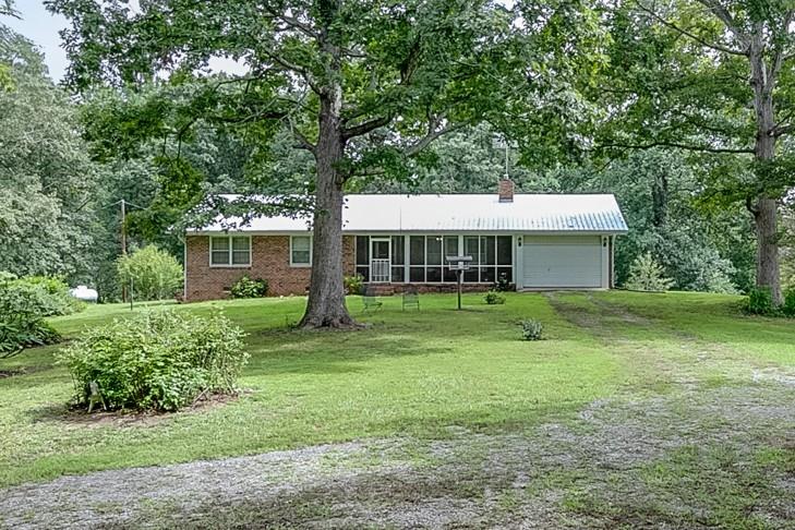 A rare opportunity in sought-after North Hall! This private, fully fenced 20-acre farm sits above the Caney Fork River at the foot of Wauka Mountain, featuring open pastures, natural springs, and unlimited water for livestock. The land has been nourished for years, producing quality hay for horses or cattle. A solid 3BR/2BA brick home with metal roof is ready for a remodel-live in, rent, or build your dream home. Multiple barns, storage buildings, and a metal shop with concrete floor and power complete the property. No HOA, zoned AG. Convenient to schools, shopping, restaurants, and medical centers, this versatile property is perfect as a working farm, investment, or private retreat.