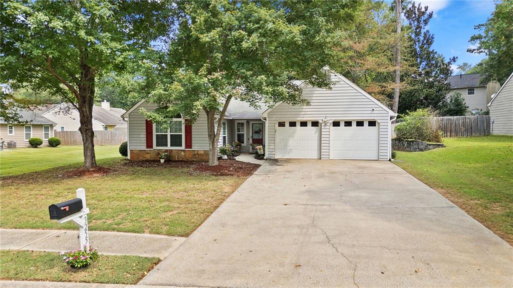 Welcome to 3255 Caley Mill Drive, a beautifully renovated stepless ranch in the heart of West Cobb — perfect for first-time homebuyers, empty nesters looking to right-size, or investors seeking a low-maintenance property with minimal HOA fees. This meticulously maintained home combines comfort, style, and convenience, offering a move-in-ready retreat with thoughtful updates throughout. Step inside to an open and airy floor plan with vaulted ceilings and abundant natural light streaming through newly installed, insulated vinyl windows. The inviting family room is the heart of the home, showcasing a floor-to-ceiling ledger stone fireplace with a reclaimed wood mantel and quartz hearth for a stunning focal point, creating the ideal centerpiece for cozy nights at home. Durable luxury plank flooring flows seamlessly throughout the main living areas and the primary suite, creating a cohesive and modern feel. The kitchen has been completely updated with granite countertops, glass tile backsplash, and stainless steel appliances — making both everyday meals and entertaining a delight. The primary suite is bathed in morning light from a large palladium window and features an en-suite bath with a walk-in shower accented by marble link tile and a mosaic stone floor. Two additional bedrooms and a full bath round out the inviting interior. Practical updates provide peace of mind and enhanced energy efficiency, including an HVAC system and water heater that have been replaced within the last 5 years. Outside, the large, level fenced backyard provides a private wooded backdrop with mature trees, ideal for gatherings, pets, or play, and is complemented by an expansive brick-trimmed patio perfect for grilling and relaxing. Nestled in a quaint and quiet community with a swimming pool, enjoy having nearby access to the Silver Comet Trail, The Avenues of West Cobb, Seven Springs Water Park, Mud Creek Soccer Complex, and countless options for shopping, dining, and entertainment. Commuting is simple with close proximity to the East-West Connector, Barrett Parkway, and local interstates, plus schools nearby. With all furniture negotiable, you can truly make this home your own with ease. Enjoy the perfect blend of modern upgrades, quiet surroundings, low HOA fees, and easy access to everything West Cobb has to offer — delivering exceptional value and everyday ease.