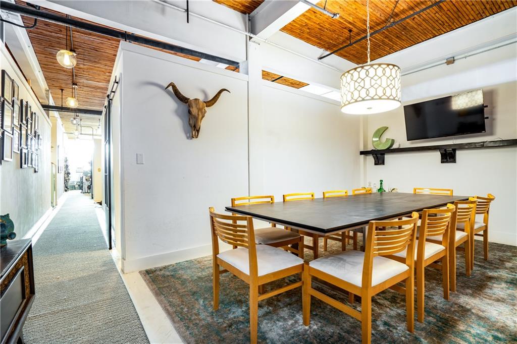 Creative-Grade Warehouse with Showroom Appeal & Turnkey Convenience. 1800 square ft, light-filled space with 3 offices & premium amenities, designed for seasoned creatives, small teams, and/or independent professionals. Features: Conference room, 2 Roku TVs, communal standing desk, full kitchen, 2 baths, 16-ft ceilings, concrete floors, exposed beams, expansive windows, and designer lighting. Kitchen includes Smeg fridge, butcher block counters, subway tile backsplash, floating shelves, matte black sink/faucet, microwave, dishwasher, pantry. Extras: Tankless hot water, high-speed commercial internet, secure entry, utilities included, flexible parking, loading dock, easy highway/transit/downtown access.