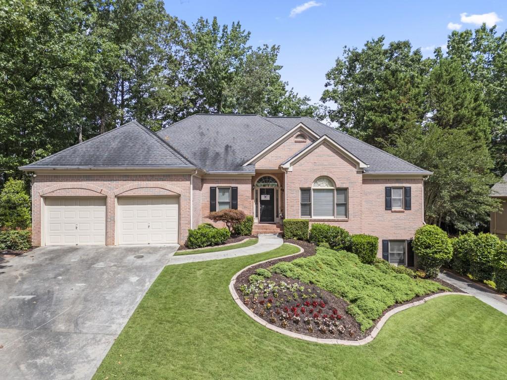 Welcome to this beautifully designed 6-bedroom, 4.5-bath home located in the desirable Fairways neighborhood in Towne Lake. With its versatile layout and full finished basement, this home is ideal for multi-generational living, in-law suites, or extended guests. The primary living spaces are conveniently situated on the main floor, including the generous primary suite with an oversized closet and en-suite bath, along with two additional bedrooms connected by a Jack-and-Jill bathroom. You'll also find two linen closets for extra storage on this side of the home. The bright, welcoming foyer opens to a formal living room with a large picture window overlooking the freshly resurfaced deck and private, landscaped backyard. The heart of the home centers around the open kitchen, complete with a breakfast room, breakfast bar, kitchen island, walk-in pantry, stained cabinets, and granite countertops-all with a view to the inviting family room. Anchoring the family room is a cozy fireplace flanked by custom built-in bookcases. French doors lead from the family room to the expansive deck, perfect for outdoor entertaining. Tucked away off the main living area is a powder room and a large laundry room for added convenience. Upstairs, you'll find a private bedroom with a full bath and walk-in storage, offering a perfect guest suite, teen retreat, or home office. Downstairs, the full finished basement-with exterior entry-features a complete apartment setup, ideal for in-laws or guests, plus a dedicated shop area perfect for hobbies, crafts, or extra storage. The basement mirrors the footprint of the main level, offering tremendous flexibility for a variety of uses. With thoughtful design, flexible living spaces, and a prime location in one of Towne Lake's most desirable neighborhoods, this home is ready to welcome its next owner. Don't miss your chance to make it yours-schedule your private tour today!