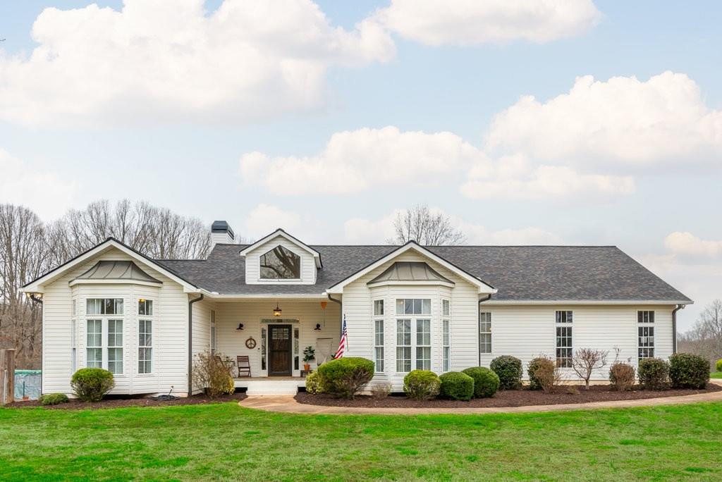 Experience the best of Forsyth County living at this hidden wonder in the charming Dunroven neighborhood, just minutes from GA400 and located just a half mile from Cumming city limits. This agriculturally zoned property offers the best of both worlds - unrestricted living in a residential setting. Located on 2 acres, this charming ranch-style home boasts a serene setting with features like a quaint chicken coop housing two happy hens, a thriving food forest yielding fresh produce, and a water catchment system for year-round sustainability. Step outside onto the expansive back deck and immerse yourself in the tranquility of nature as you watch the breathtaking sunset with complete privacy. Natural light floods every corner of the home through numerous windows, creating a warm and inviting atmosphere. Meticulously cared for and thoughtfully updated, this home exudes both practicality and beauty. Revel in the elegance of newly updated wood flooring, bathrooms, kitchens, and laundry room, all professionally designed to perfection. Custom-built cabinetry and ample storage solutions are seamlessly integrated throughout, providing both functionality and style. Indulge your culinary passions with the new stainless steel appliances adorning the beautiful kitchen. Whether you’ve always dreamed of raising chickens and goats, or prefer to enjoy the peaceful surroundings without them, the choice is yours! There is even an optional HOA should you want to enjoy fishing or kayaking on the Dunroven neighborhood lake. This home is located 3 minutes from NoFo Brew Co where you can sit on the patio & soak in some live music, or just a short drive to Halcyon, Cumming City Center, Alpharetta, Dahlonega wineries, 7 minutes to Lake Lanier, and so much more. If you want access to all the modern amenities, while still escaping from the hustle and bustle, this is the property for you.