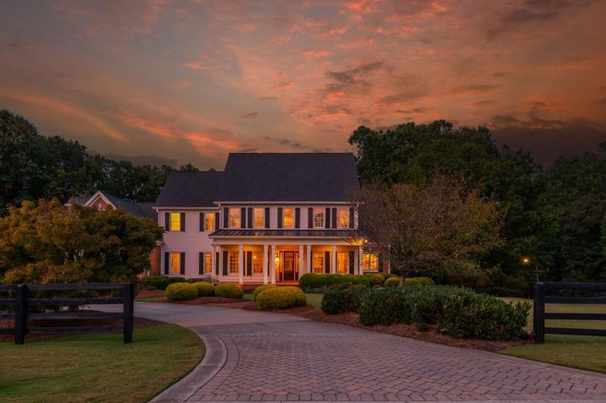 Experience timeless elegance and serene living in this custom-built estate by award-winning Chatham Homes, set on 2.5 acres in the exclusive Shoals at Arbor Hill community. This 6-bedroom, 6.5-bath residence showcases refined craftsmanship and luxurious details throughout. A welcoming Southern porch and dramatic two-story foyer lead to a large dining room with exquisite architectural accents. The living room features a coffered ceiling, built-ins, and French doors opening to a spacious deck overlooking the private backyard. Additional highlights include a butler's pantry, laundry room with office space, and abundant storage. The gourmet kitchen is the heart of the home, offering stainless steel appliances, custom cabinetry, an oversized island, and expansive counters, flowing seamlessly into a bright keeping room with fireplace. The main-level owner's suite is a private retreat with fireplace, sitting area, dual walk-ins, and a spa bath with soaking tub, dual vanities, and walk-in shower. Upstairs are four en-suite bedrooms, each with a walk-in closet. Enjoy outdoor living from the covered porch or terrace level, complete with bedroom suite, kitchenette, recreation space, and storage. The grounds feature a French-style garden, koi pond, stone fire pit, and custom stream with waterfalls. Adding to its appeal, The Shoals at Arbor Hill is an equestrian-friendly community, allowing horses on property with HOA approval -a rare lifestyle opportunity. Minutes from shopping, dining, and top-rated schools, this home offers unmatched luxury, privacy, and serenity. Welcome Home.