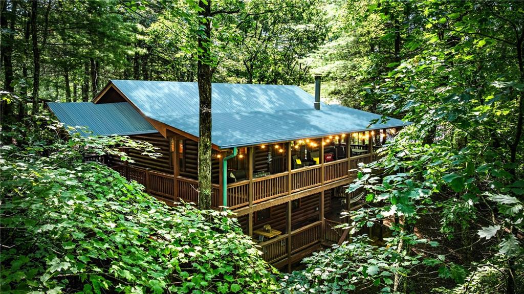 Amazing deal! Looking for a quick close. Don’t miss out on this opportunity. This is a true log mountain getaway! Enjoy the Cherry Lake community offering community lake access. You can also walk the Benton McKaye trail which meanders thru the development. This is minutes away to downtown Blue Ridge! This sweet 2 BR, 1 BA cabin offers a 2+ car carport, a back up generator and a hot tub. The 2 bonus rooms downstairs could be used as a third bedroom, studio, craft room, workshop, extra living room, or game room - the choice is yours! This cabin offers a wood burning fireplace, oversized decks w/grilling porch, end of the road privacy and it is the perfect vacation home, second home or rental property. Come see for yourself!