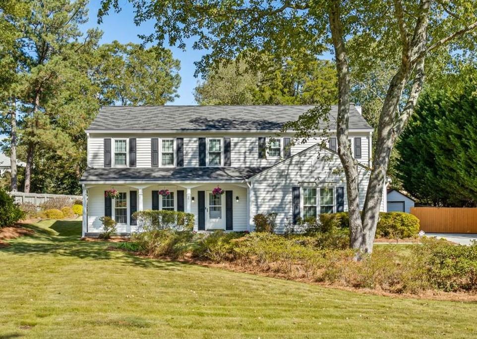 The best curb appeal in the neighborhood! Lovingly owned and cared for by the same family for over 40 years, this meticulously maintained 4-bedroom, 2.5-bath home sits on a level 0.52-acre lot on a peaceful cul-de-sac. The main level features gleaming hardwood floors; a separate living room; cozy family room with stone gas fireplace and built-ins and a kitchen that was thoughtfully updated. Enjoy outdoor living on the screened porch and adjoining deck, perfect for relaxing or grilling with friends. Upstairs you will find the oversized primary suite that offers abundant space and a generous closet; 3 more bedrooms and a hall bath, accessible from one bedroom. The level landscaped yard has room for a pool, playset, and firepit. There is great shed out back, for more storage. Recent updates include a new driveway, new windows, gutter guards, and a full irrigation system—all adding to the comfort and value of this timeless home. Neighborhood has no HOA. Fantastic East Cobb location close to highways, schools, shopping, restaurants, The Battery and parks and in a top school district. This wonderful home is just waiting for it's next family to make it their own!