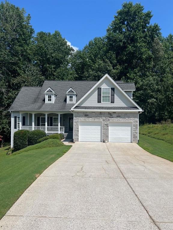Welcome home to this beautifully maintained 3-bedroom, 2-bathroom ranch situated on a spacious 0.75-acre lot in a quiet, established neighborhood. Tucked away in a cul-de-sac, this home offers privacy, tranquility, and a layout perfect for both everyday living and entertaining. Step inside to find a bright, open floor plan with soaring ceilings and gleaming hardwood floors throughout the main living areas. The kitchen features ample cabinetry, generous counter space, and a cozy eat-in area, complemented by an open concept dining room. A large bonus room upstairs adds flexible space for a playroom, media room, or home office. The spacious primary suite includes a flex space perfect for a sitting area or office, a large walk-in closet, and an en suite bath with a double vanity, separate shower, and soaking tub. Two additional bedrooms are well-sized and share a full hall bath. Enjoy year-round outdoor living on the screened-in back porch overlooking a beautiful backyard. A large deck provides even more room for entertaining friends and family. The unfinished basement offers plumbing for an additional bathroom, abundant storage and endless possibilities, create a home theater, gym, craft room, or customize it to fit your family's needs. Conveniently located near GA 400, Lake Lanier, and the North Georgia mountains, this home truly has it all. Don't miss your opportunity to own this move-in ready gem in a prime location! Professional photos coming soon.