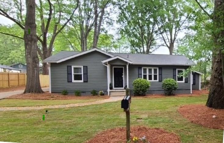 Newly updated, spacious ranch in an incredible location - walking distance to elementary school, close to shopping, interstate, and across the street from the Sewell Mill Library and Cultural Center, and Sewell Mill Park with pickleball and tennis courts, a playground, and a pool! The updates include new exterior and interior paint, new roof, newly refinished hardwoods, new flooring, all new kitchen appliances, updated owner's bathroom, new back steps, and new wood privacy fence, including double gates. Note: the fence does not run the entire lot. There is additional land behind the fence at a triangular angle. The survey was recently completed, and the stakes are in the ground. Could push fence back to add playground, shed, etc.