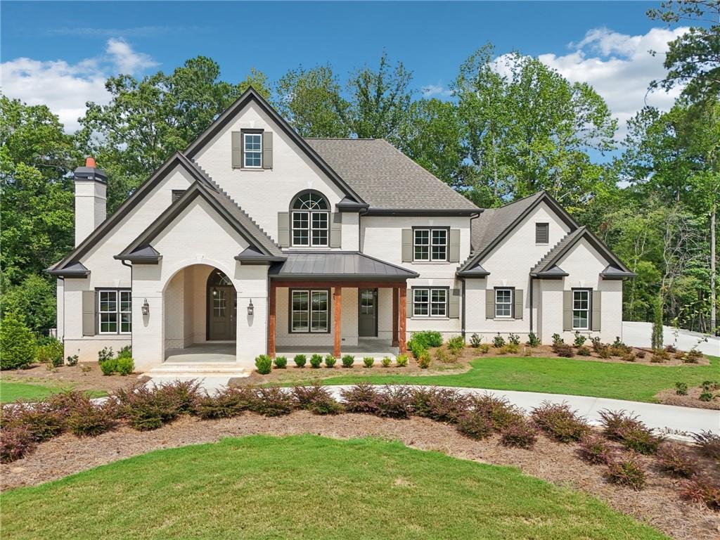 Discover one of the most exceptional locations in Governors Towne Club—this custom-built, impeccably crafted home sits on an extraordinary lot with sweeping views of hole #5 in the front and the tee for #6 just beyond the private back porch. From the moment you arrive, the painted-brick façade, stately arched entryway, and tongue-and-groove ceilings set the tone for timeless elegance. Inside, gleaming hardwoods lead through a soaring coffered-ceiling great room with fireplace, while the gourmet kitchen boasts an oversized quartz island, pro-grade range and hood, walk-in pantry, and butler’s pantry to the formal dining room. The main level also features a private office with fireplace, screened porch, and an opulent primary suite with porch access, dual custom closets, soaking tub, and frameless shower. Every bedroom is a private en-suite with walk-in closet. Outdoor living includes a covered front porch, screened porch, open-air deck, and covered terrace with serene, never-to-be-disturbed views. A horseshoe driveway, 3-car garage, and professionally landscaped grounds complete the picture. Built by a highly reputable local builder, this home includes the seller-paid $30,000 Governors Towne Club initiation fee—your gateway to a vibrant social membership with access to world-class amenities including a resort-style pool with waterslide, full-service spa and fitness center, tennis and pickleball courts, clubhouse dining, year-round social events, and the peace of mind of 24/7 gated security with a staffed guardhouse. Thank you for scheduling your tour—this is a home and community experience you’ll never forget.