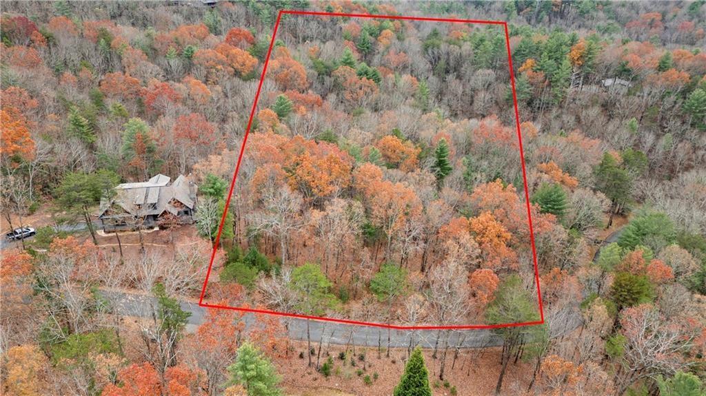 Nestled in the serene Turkey Knob Estates, this 2.15-acre wooded lot at 00 Oceola Drive, Ellijay, GA, offers breathtaking mountain views and the perfect location to build your dream home. With a gentle slope providing optimal natural light and privacy, this lot creates a peaceful retreat while being just 15 minutes from downtown Ellijay. Enjoy the charm of this mountain town, known for its wineries, hiking trails, apple orchards, and abundance of outdoor activities. The property offers a unique blend of tranquility and convenience, with easy access to shopping, dining, and entertainment. Whether you’re planning a primary residence or vacation retreat, this stunning lot combines the beauty of nature with proximity to modern amenities. Don’t miss your chance to own a slice of paradise in North Georgia’s mountains—schedule a visit today! Seller financing available.