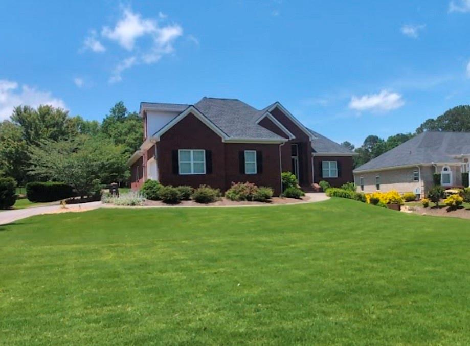 Charming Ranch in Sought-After Championship Oak Mountain Golf subdivision! Welcome to 103 Champion Drive, a beautiful ranch-style home nestled in a quiet, established neighborhood. And even better it overlooks the green on the 8th hole. This inviting residence features 5 spacious bedrooms and 4 full bathrooms, offering a comfortable and functional layout perfect for entertaining. Step inside to discover an open-concept living and dining area filled with natural light, a cozy fireplace, and hardwood flooring throughout. The kitchen boasts ample cabinet space, updated appliances, and a convenient breakfast nook—ideal for casual dining. The owner’s suite includes an en-suite bath with vaulted ceilings, generous closet space, and tray ceilings. Four additional bedrooms provide flexibility for family, guests, home office, or hobbies. Outside, enjoy your level backyard, perfect for outdoor entertaining, gardening, or simply relaxing. The fully finished basement offers incredible versatility, featuring a private bedroom, two spacious living areas, a dedicated office or potential sixth bedroom, a full bathroom, and a second kitchen - ideal for guests and in-laws. This home also includes a two-car garage on the main level plus an additional garage in the basement. Recent updates include a new roof, water heater, and dishwasher - all completed in 2023. Conveniently located just minutes from downtown Carrollton, schools, shopping, restaurants, and the University of West Georgia. This move-in ready home combines comfort, location, and value - don’t miss this fantastic opportunity!