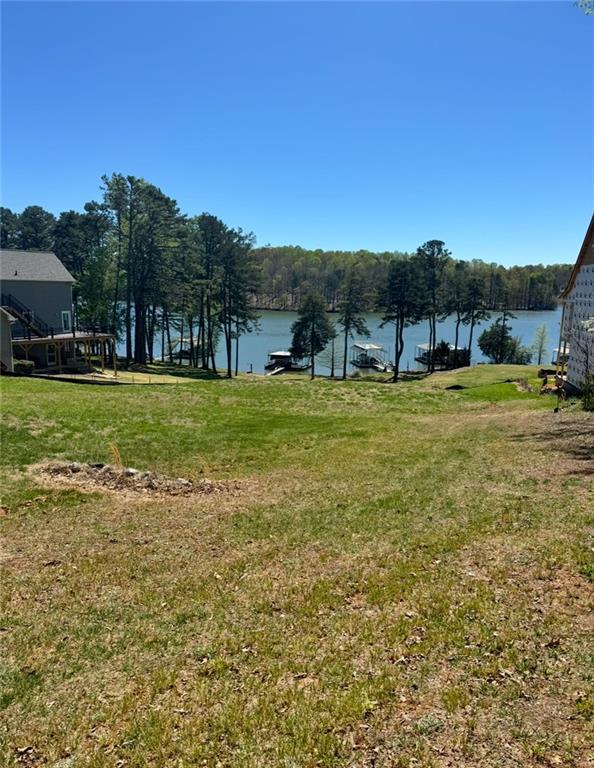 Rare Opportunity –Lakefront Lot in Dawsonville!
Don’t miss this exceptional .79-acre Lake Lanier lot—never before on the market! A completed Level 3 Perc Test and survey have been done, this property is ready for your dream home. Enjoy stunning, wide-open views of the lake with grassy frontage that gently slopes to the water—ideal for a walkout basement or future pool overlooking the serene shoreline. Located just minutes from Highway 400 via Kilough Church Road, this prime spot offers both privacy and convenience. While the lot does not include a dock, it’s perfectly positioned between Thompson Bridge Park and Nix Bridge Park, making lake access simple and hassle-free.
