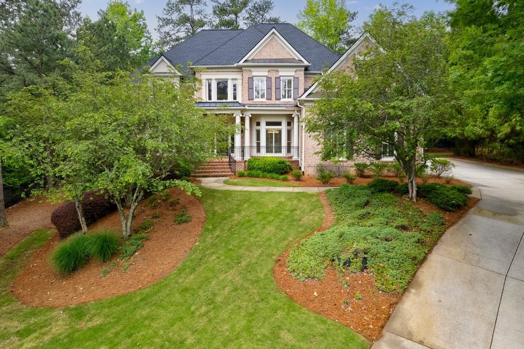 Immaculately maintained estate with timeless rich architecture. This home welcomes you with a covered brick and stone porch. As you enter the home, you will be captivated by the beautiful two-story foyer, featuring marble floor with a staircase sets the style for the rest of the home's elegant high-end finishes. Adjacent to the staircase, you will find the entry to the gentleman's Library/office with raised bookcases, on the other side of the formal library you have  very large formal dining room with  bay window. Walk into the main level 2 story Great Room with a wall of windows and elegant  2 story fireplace. Turn into the Family room area with two story Cathedral ceiling and a fireplace surrounded by bookshelves. The main level also includes a spacious bedroom with a full bathroom. The expansive gourmet kitchen is a chef's delight, with stainless steel appliances, granite countertops, custom cabinets, and a large center island perfect for food preparation and entertaining guests. The kitchen also features a breakfast area and a walk-in pantry. You can walk out to the large deck to enjoy a view of the peaceful leveled wooded backyard. there 2 half baths on the main level with a large laundry and a very spacious mud room area. This home features a total of six bedrooms six full bathrooms and two half baths, including a spacious owner's suite with ultra deep trey ceiling, complete with a sitting area, large walk-in closet, and a luxurious spa-like bathroom with dual vanities, a soaking jetted tub, and a separate shower. The upper-level features three additional bedrooms all with their own en-suite bathrooms. Spacious finished Terrace Level with Home Theater, Bar, Bedroom, Office Room, Exercise Room, Pool Table Room and sitting area and a office room. The high-end finishes and attention to detail throughout the home exemplify luxury living, with features such as crown molding, hardwood floors, and custom built-ins. The home also features a three-car garage, providing ample parking and storage space. This is a rare opportunity to own a luxurious home in a gated guarded number 1 country club of Atlanta. This home is offering the perfect blend of comfort, elegance, and entertainment truly a great opportunity to move into a three levels finished home at such lucrative price. Your Perfect Dream Home in Sugarloaf Country Club.