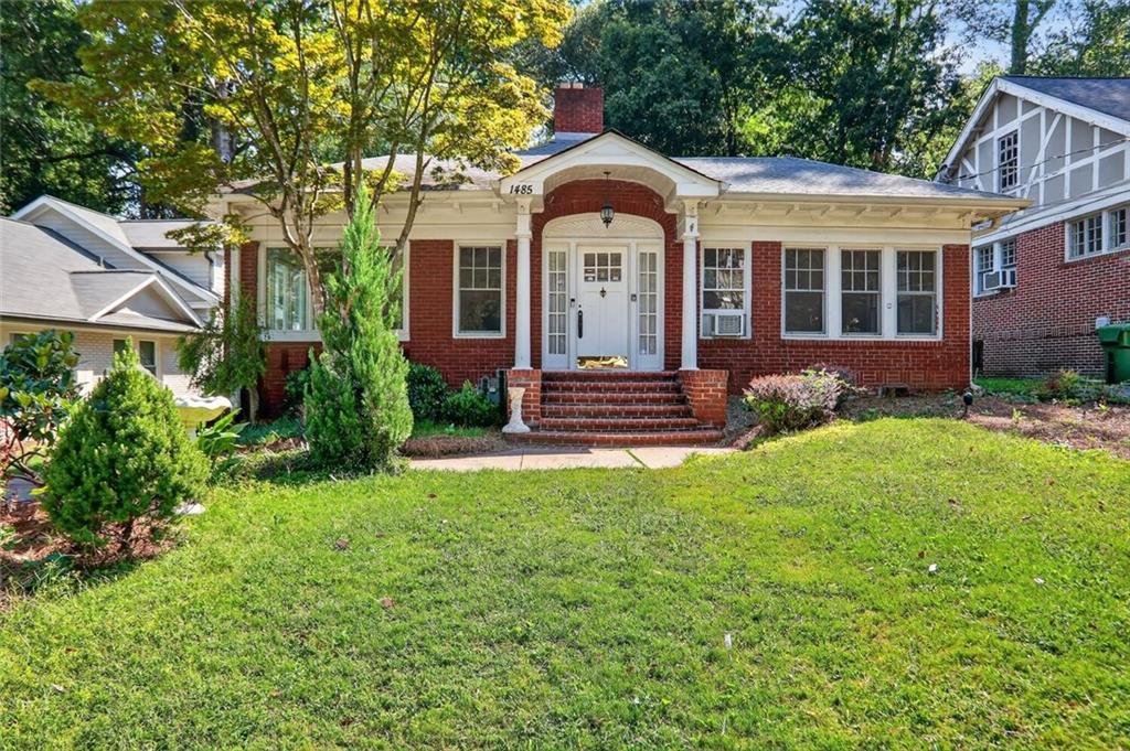 Quarter-Acre Craftsman Bungalow with Character, Space & Endless Possibility
Nestled on one of Morningside’s most beloved tree-lined streets, this classic 1928 red-brick Craftsman bungalow sits on a rare quarter-acre lot with a deep backyard and gentle slope—offering charm, flexibility, and future potential for both end-users and builders.
From the welcoming front stoop and original architectural details to the spacious footprint and mature landscaping, this home is filled with timeless character. Inside, you'll find a formal living room with a beautifully mantled fireplace as the centerpiece of the room, a bright sunroom perfect for a home office or reading nook, and a versatile sitting room that can function as a third bedroom or secondary workspace. A formal dining room connects to a functional kitchen with stainless steel gas range and microwave, and a dedicated laundry room.
At the rear of the home, a large family room with oversized windows overlooks the backyard, bringing in tons of natural light. A spiral staircase leads up to a finished loft and attic storage space, adding even more versatility. The primary suite, tucked at the back of the home, features multiple closets and a private bath with dual vanities, an original claw-foot soaking tub, and a separate shower. Off the family room is a deck with stairs that lead down to the deep backyard, where you'll find a small lawn-equipment carport and a shed for additional storage.
A wide front yard and a deep, gently sloped backyard make this property perfect for those looking to enjoy it as-is, renovate, or build new. The lot size and layout offer incredible flexibility—making it an ideal candidate for thoughtful expansion or a ground-up custom build in one of Atlanta’s most sought-after neighborhoods.
Just steps from the dining at Morningside Village, Alon’s Bakery, Orme Park, and minutes from Virginia Highland and the BeltLine, this is a rare opportunity to own a piece of intown Atlanta with both historic charm and development upside.