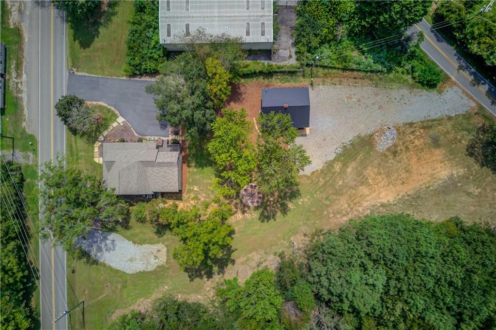 *Assemblage of 2 properties: 6700 Shady Grove Rd & Parcel #: 273 004. List price for the assemblage is $2,348,000.00. *
*6700 Shady Grove Rd(Parcel #: 273 005) - Approximately 2,092 +- SF stand-alone building for sale, zoned Neighborhood Shopping that sits on 1 +- Acre. Originally built in 1926 as a farmhouse, this unique property has been thoughtfully and completely restored. The renovation preserves the timeless charm and character of the structure while seamlessly integrating modern upgrades and comforts throughout the main level. The main level features a reception area, 4 offices, 1 conference room/5th office, Full kitchen + breakroom + pantry, sitting area off kitchen, private restroom, & washer/dryer hookups. The upstairs is one flex room/Loft. Front and back porches ideal for outdoor seating. Outdoor firepit and gathering area in the back yard. The 2nd building on the property is 1,000 +- SF and is new construction with 2 custom drive in doors. It can be built out for office space if so desired or be used as one large open space. The 1,000 +- SF building has its own driveway and address that exits onto Heard Rd.
*Parcel #: 273 004 is approximately 4.18 +- Acres of land zoned Commercial: Neighborhood Shopping. Dual Road frontage on Shady Grove Rd and Heard Road. Less than 1 mile from Lake Lanier & major public boat ramp. The only commercial zoned property on this unique peninsula. Surrounded by one of Forsyth County's highest median income communities, offering premium visibility and strong demographic support. Neighborhood Shopping permits a mix of office and retail uses; you will need to check with Forsyth County to verify permitted commercial uses. Soil tests are available. Survey available. Floor plans available. Showings are by appointment only.
*Approx. 3.8 miles to GA 400 via exit 18. Near Grocery and dining options on Browns Bridge Rd/State Hwy 369.*
*All information is believed to be accurate but not warranted. It is the purchaser's sole responsibility to verify all information.*