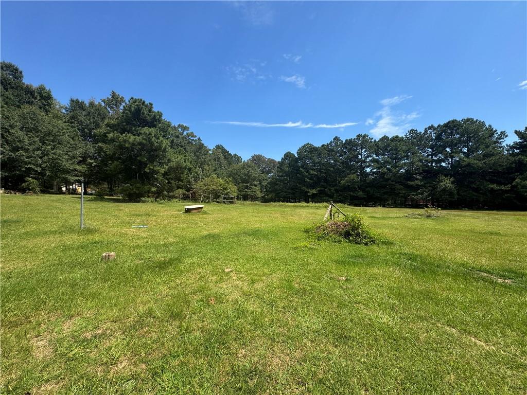 Discover the perfect opportunity to build your dream home on this 3.46-acre flat and open property. Featuring two driveways for easy access and a storage shed already on site, this land is ready for your vision. With water and power available at the road, the groundwork is set for a smooth build.
Enjoy the privacy and space of country living while still being just minutes from Hiram, Dallas, Lithia Springs, and quick access to I-20. Whether you’re looking to create a custom estate, add a hobby farm, or simply enjoy open land with room to grow, this property offers endless potential.