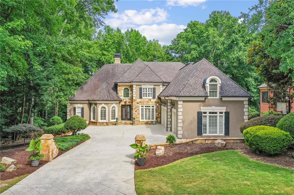 Looking for a home that offers lots of beautifully designed and thoughtfully laid out Square Footage and Living Space? Look No Further! Amazing 8 BEDROOM, 8.5 BATH, 8000 SF, 4 GARAGE, 2 LAUNDRY ROOM, 2 MASTER BEDROOM SUITES (1 ON MAIN, 1 UP), FINISHED TERRACE LEVEL with HOME THEATRE, LEVEL FRONT AND BACKYARD - ON THE GOLF COURSE AND A CULDESAC home in gated Saint Ives Country Club, top Johns Creek Schools! Best Lot in the community, a quiet Cul-De-Sac on the Sixth Fairway! Renovated Deck overlooks the Level, very Private Backyard, with new Putting Green and perfect for a Pool! The view is not to be missed! Primary Suite on the Main with a Newly Renovated, Completely Customized Spa-like Bathroom - featuring His and Her Separate Bathrooms each with Heated Floors, Heated Towel Racks and Electric Skylights! You must see it to believe, not a detail has been overlooked, including the large Double Shower with Two Frameless Glass Doors. ALL BATHROOMS have been Beautifully UPDATED! The Kitchen is perfectly appointed featuring Vaulted, Tiered Ceilings and Crown Molding, A Subzero Refrigerator, Double Refrigeration Drawers and Two Warming Drawers. The Family Room, Breakfast Room and Kitchen are a true Open Concept boasting Nazareth Stone on the floor and the baseboards, Jerusalem Stone for backsplash, and you will be wowed by the Custom Cherry Wood in the Unique Vaulted Breakfast Area and Family Room. The home features three Wet Bars, all with Refrigerators or Icemakers. Closets are everywhere, many Walk In and Custom Designed. The home also features a large Cedar Closet on the Terrace Level. The Terrace Level is beautifully finished and features a Media Room with a 10 foot Screen and nine Recliners on two levels which stay with the home. The home features three 50 gallon Water Heaters. The Flooring is gorgeous, with primarily Engineered Distressed Hickory on the Main and Finished Terrace, and partial Carpeting upstairs which is Newer and Stain Resistant. There are two Laundry Rooms - one on the main level and one upstairs. This house actually features Two Master Bedrooms, one on the main and one upstairs, designed purposefully so if one of the children was ill, a parent had a master bedroom upstairs in which to sleep in close proximity to the child. Not a detail of this house has been overlooked by the original owners, custom built by Craftmaster homes and designed by Steve Fuller. You will not be disappointed!