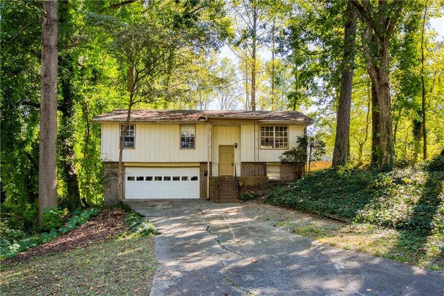 OPPORTUNITY awaits in Mill Court, an established neighborhood just minutes from Chamblee, Buford Highway Farmer’s Market, Brook Run Park, and the DOWNTOWN DORAVILLE REDEVELOPMENT PROJECT. Perfectly situated near I-285, I-85, MARTA, Schools, Restaurants, and Shopping, this property offers easy access to everything while providing a solid foundation for your next INVESTMENT or RENOVATION project.
This bi-level home features three bedrooms, two full baths, and an unfinished basement with a two-car garage — offering the flexibility to reimagine and expand the layout to suit your needs.
Enter through the front door to a SPLIT STAIRCASE leading up to the main living area and down to the unfinished lower level. The main floor includes an open family and dining space with sliding glass doors to the REAR DECK, a spacious kitchen with a casual eat-in area, and a hallway leading to the primary ensuite, two additional bedrooms, and a full hall bath. The lower level connects to the garage and includes the laundry area, with ample storage or workshop potential.
With 1,239 square feet above grade and room to grow below, this property presents strong POTENTIAL for value creation. Whether redesigned as a long-term rental, a resale, or a customized home, the structure and location set the stage for lasting return.
Recent probate clearance makes this home ready for transfer and renovation. The property is being sold AS-IS, and conditions conducive to mold may exist. Buyers are encouraged to conduct full inspections as part of their due diligence.
Less than two miles from the planned 13-ACRE MIXED-USE redevelopment of Downtown Doraville — with future green spaces, restaurants, walkability and BeltLine/Greenway connectivity — 2631 Mill Court represents a promising opportunity to invest in a community on the rise.
(Property sold AS-IS. Cash or renovation financing recommended.)