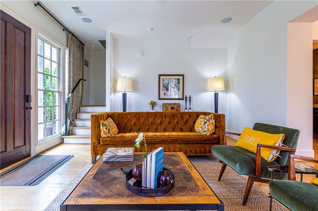 Living room featuring wood finished floors and stairway