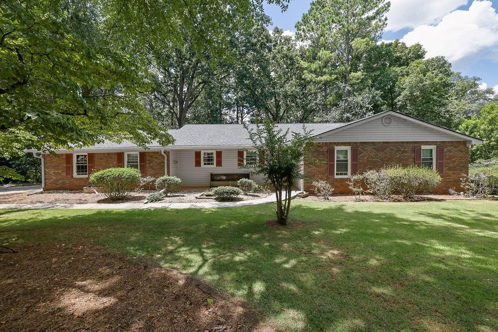 Get ready to call this house your next home or investment property! This 4 sided brick ranch on a finished basement is located in a community without any community association or rental restrictions. The seller has taken great care of the home and has made several updates which include: New Roof (2025), New HVAC (2025), New Water Heater (2025), New Electric Box (2025), Fresh Paint, and much more. The main level features an open floorplan where the kitchen opens up to both the dining room and family room, 3 bedrooms, 2 full baths, and access to a screened in deck. Hardwood floors run throughout the common areas and the primary suite. The primary suite boasts an updated bathroom (2023). The lower level details a bedroom, full bath, laundry room, 2 unfinished rooms perfect for storage, and a large common room with a fireplace. The backyard is fenced and wooded - allowing for privacy. The Kennesaw Mountain Battlefield entrance is right outside the neighborhood and ready to be enjoyed by any fitness enthusiast or history buff. This house is a short drive to Kroger, Downtown Marietta, and endless shopping, dining, and recreation options. Located in the amazing Marietta High School district with Burress Elementary and Marietta Middle as the feeder schools. This house will not last long, get your offers in today!