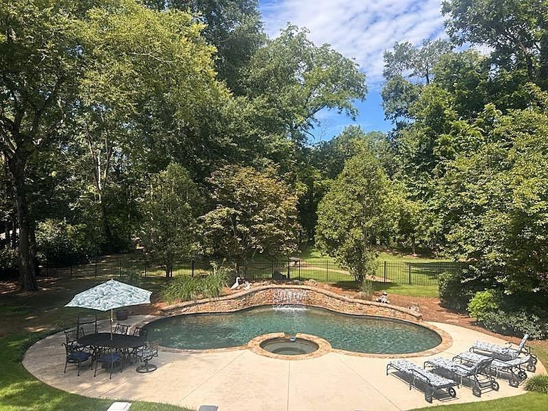 UNDOUBTEDLY THE MOST GORGEOUS LOT IN SWEET BOTTOM PLANTATION!!!!Exquisite Riverfront Estate with Unparalleled Charm. Nestled on a picturesque 1.45-acre lot along the Chattahoochee River, this stunning 4-bedroom, 5.5-bath estate embodies the elegance of classic Southern living. Constructed with four-sided brick, this home seamlessly blends timeless charm with modern luxury. Step into the inviting foyer, flanked by a banquet-sized dining room and a formal living room, setting the stage for refined entertaining. The chef’s dream kitchen boasts stainless steel appliances including brand new ovens, stone countertops, a walk-in pantry, and a dedicated breakfast room, all open to a spacious fireside family room. Step onto the partially covered rear deck and take in breathtaking views of the river. A stately office with built-in bookcases and a wet bar offers an ideal space for work or study. Upstairs, two expansive suites feature private office/study areas, walk-in closets, and ensuite baths, each with access to the charming front balcony. The master suite is a true retreat, complete with a cozy fireplace and a private screened porch overlooking the lushly landscaped backyard and river views. The newly renovated master bath exudes spa-like luxury, featuring a jetted tub, steam shower, tankless water heater, electric toilet, heated floors and towel racks, and custom walk-in closets. Brand new carpet on second level. Seller is also having new roof installed. The terrace level is an entertainer’s dream, offering a media room or 4th bedroom, sunroom, full secondary kitchen with wine cooler, stove, microwave, and dishwasher, a billiard room, and two full baths. Outdoor living is just as spectacular with a gorgeous in-ground pool and hot tub, complete with newer pool equipment. Enjoy sweeping river views from multiple vantage points, while Trex decking, a gated driveway, newly refinished hardwood floors, and plantation shutters add the perfect finishing touches. .This one-of-a-kind estate is an extraordinary blend of luxury, comfort, and breathtaking natural beauty. Don’t miss your chance to own this riverside masterpiece!