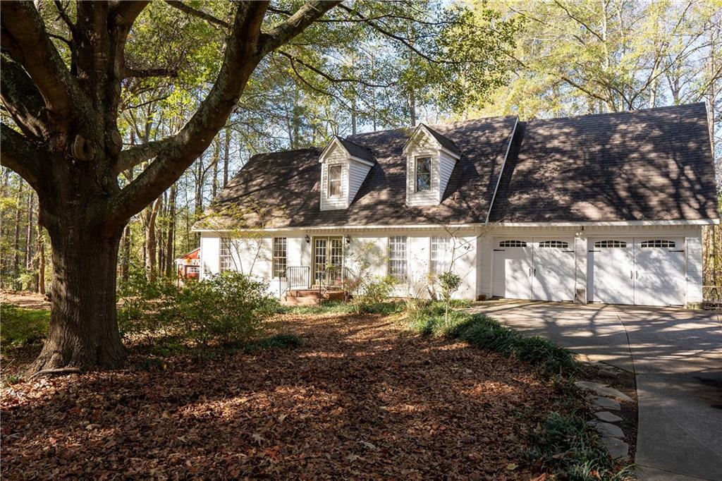 Come explore this charming one owner home with a spacious half acre lot in the sought after Hillgrove school district! Upon entering, you are greeted by beautiful hardwood floors in the foyer that flow throughout the main living area. The spacious living room offers a comfortable, inviting space to relax or entertain, an abundance of natural light, and a fireplace for those cozy winter nights. The eat-in kitchen offers ample cabinet space and solid surface countertops, and the separate dining room is perfect for entertaining. You'll also find the laundry and a full bath on the main level. Retreat upstairs to the oversized master suite with a full bath. Down the hall are two roomy additional bedrooms and an additional full bath. Outside, enjoy half an acre of land to call your own, where you can relax on the patio with a morning coffee and have an outbuilding for extra storage. This home offers a newer HVAC system and septic tank was pumped in 2023. Don't miss the opportunity to experience this slice of heaven, so close to all West Cobb has to offer AND UNDER $400K! Schedule your showing today!!!