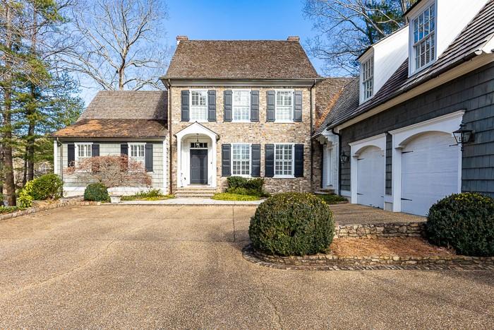 Truly a rare opportunity to be in Vinings on Paces Lake. This custom home was built in 1998 for the current and only owner of this high quality home that has unparalleled lake views from almost every room in the house. Cape Cod design with the primary suite on the main floor. Enjoy the low Cobb County taxes with easy proximity to all the private schools.
Sited gracefully on this private lot, the view through the open front door offers a straight vista from front to the back of the home with the lake just beyond. The orientation of the home provides exceptional natural sunlight throughout the home all day long. Parking spaces abound in the front courtyard.
A central hallway feeds effortlessly into a gracious dining room , the living room, the sunroom and the primary bedroom suite. As you walk through the home, each step takes you to an inviting room and sense of comfort.
The gorgeous heart pine lined kitchen is a paradise for true chef who doesn’t want to miss out on family gatherings. The kitchen, breakfast area and sitting area are adorned with a warm brick and mortar fireplace encouraging gatherings for all. Double oven and 8 burner stovetop by Thermador, 2 dishwashers, Sub -Zero Refrigerator/freezer and an icemaker provide everything one needs for the largest families or crowds.
Step from the sunroom or sitting area onto a slate lined patio with an outdoor fireplace with an epic
view overlooking Paces Lake.
There is a side family and friends entrance off the driveway, opening to a gracious brick floored mudroom two steps away from the three car garage with a slate floor! From this family and friends entrance there is a sperate back stairway to a bedroom and office suite above the garage and steps to the kitchen and ground floor laundryroom with ½ bathroom.
Yet another large fireplace serves the separate, central living room for the house. Seating is plentiful for all large gatherings.
The most fabulous rooms in Vinings await you with a large window lined sunroom overlooking the most gorgeous view of Paces Lake. Off this sunroom, a private doorway leads you to an primary suite like no other. Exterior wall is a solid wall of windows with views to the lake. What a way to start your day! Sperate his and her closets, a separate water closet with a bidet and urinal serves everyone well! A large shower, separate soaking tub and double vanities provide comfortable amenities for everyone.
The second floor in the body of the home has two large bedrooms with ensuite bathrooms and huge closets. A finished storage/ play area is available if needed. A walk up set of stairs provides easy access to the unfinished attic area.
The terrace level has a theater room, one gameroom overlooking the lake, another interior gameroom, a 2000 bottle wine cellar, a full bathroom and a gym that could easily be converted to another bedroom if needed.
For a quiet moment, take the steps down to the private dock on the lake. Have a cup of coffee in the morning or take a quick paddle in the canoe around the lake.
If you want your family and friends to be drawn to your home for comfort, this is the house