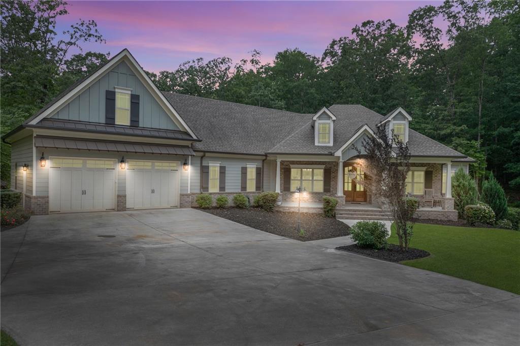Welcome to this stunning custom built 5-bedroom, 3.5-bathroom home nestled in a serene, wooded setting on a beautifully landscaped lot. Enjoy peaceful mornings on the charming rocking chair front porch before stepping into an inviting open floor plan featuring beamed ceilings, a cozy fireplace, and built-in bookcases, and beautiful wide white oak plank floors.
The gourmet kitchen is a chef’s dream, complete with a large granite island, farmhouse sink, wine refrigerator, and a spacious walk-in pantry. It flows seamlessly into the elegant dining room and an office with French doors and a coffered ceiling. Step out onto the screened deck to take in the beauty of your private, wooded backyard.
The lovely owner’s suite offers a spa-like ensuite bath with a soaking tub, double vanities, and a separate shower. The oversized walk-in closet has a beautiful chandelier! The closet is conveniently connected to to a spacious laundry room. On the opposite wing, you’ll find three additional bedrooms and a full bath.
Above the garage is a massive finished bonus room perfect for guests, hobbies, or a playroom. The finished basement is an entertainer’s paradise, offering a full kitchen with built-in kegorator, a large dining area with abundant cabinetry, family and game room space, a full bedroom and bath, plus a flex room ideal for a gym, office, or 6th bedroom. There's even a secure safe room!
With multiple indoor and outdoor living spaces and endless versatility, this home truly has it all. Don’t miss your chance to own this one-of-a-kind retreat!