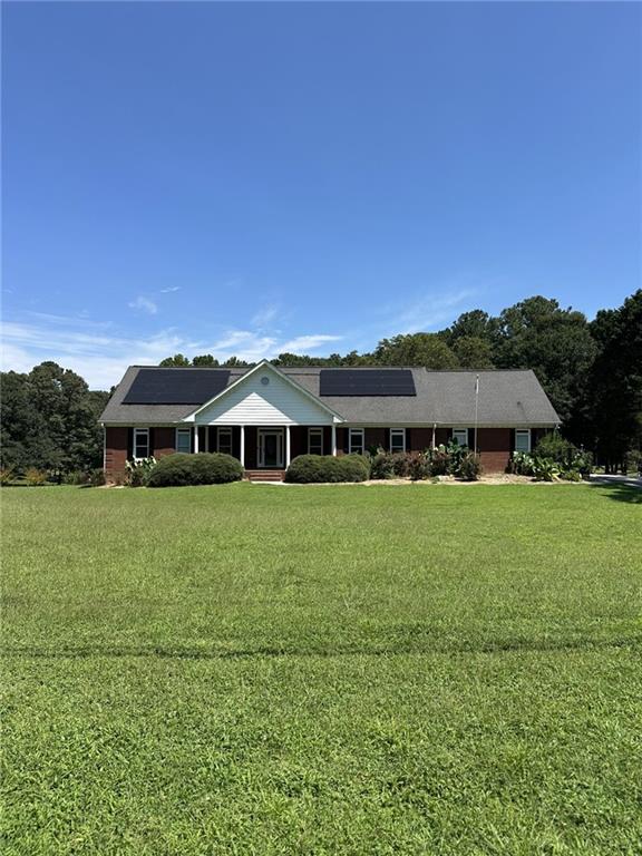 Bring the family & the animals to this small Gentleman's farm! A bit of country but so close to the city-easy commute! 4-sided all brick ranch located on 4.5 acres includes barn with workshop, hay room and stable, included 3 fenced pastures completely fenced in allows you to raise animals. There's plenty of room to add a pool, garden, playhouse or whatever you may want to complete your outdoor living. The possibilities are endless as no HOA. Inside the home you'll find a kitchen the whole family can gather to cook in together or sit and visit while you cook. The hardwood floors are in tip-top condition and are through out the home. Make the sunroom you're sanctuary. It looks over the peaceful private property and has adjoining deck. You'll also find a complete finished in-law suite in basement with living room, fireplace, full kitchen, full bath and additional bedrooms. There's also additional storage in the basement. Additional extra's include 6 person newer hot tub, pellet stove, 3 yr old solar power system (lower power bills!!) handicap accessible with 36' doors, 4 car detached carport, Interior freshly painted in July 2025, Basement LVP July 2025 - Well sought after Archer School district! You'll fall in love with this hard to find All Brick ranch on acreage!! This one won't last!