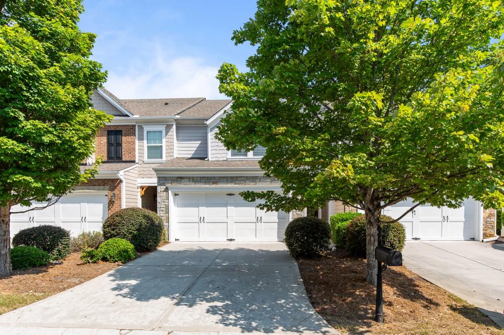 WOW! This home is perfect, just like brand new! Welcoming two-story foyer entryway, spacious family room with gorgeous built-in shelving and beautiful gas fireplace open to the kitchen and dining room. Wood floors throughout the main level. This home is bright and airy with upscale Plantation Shutters and new recessed lighting throughout the home. All new light fixtures, too. Large eat-in kitchen with NEW painted white cabinets, NEW oven, dishwasher, disposal, and microwave! Also, the refrigerator, washer, and dryer will stay. Spacious laundry room with shelving is conveniently located off the kitchen. Desirable plan with a large two-car garage at kitchen level to avoid an extra set of stairs, with plenty of extra storage shelving, which will stay along with rubber floor mats. Upstairs, you will find the Oversized Primary Suite with huge walk-in closet and lovely bathroom with double vanities, and a separate shower and tub. The secondary bedrooms are large and can easily be used for another den or office as needed, with a separate hall bath. Fresh paint and carpet throughout! Rear deck just refreshed and painted and looks like new. Hurry, you will not be disappointed. Located in fantastic Suwanee Station, amenities including large Swim/Tennis, playground and parks. Community is Walkable to the Fresh Market, Restaurants, and LOTS of other shopping, near Sugarloaf Parkway and great schools! Just minutes to award winning Suwanee Town Center and local breweries! Please use ShowingTime for easy showing.