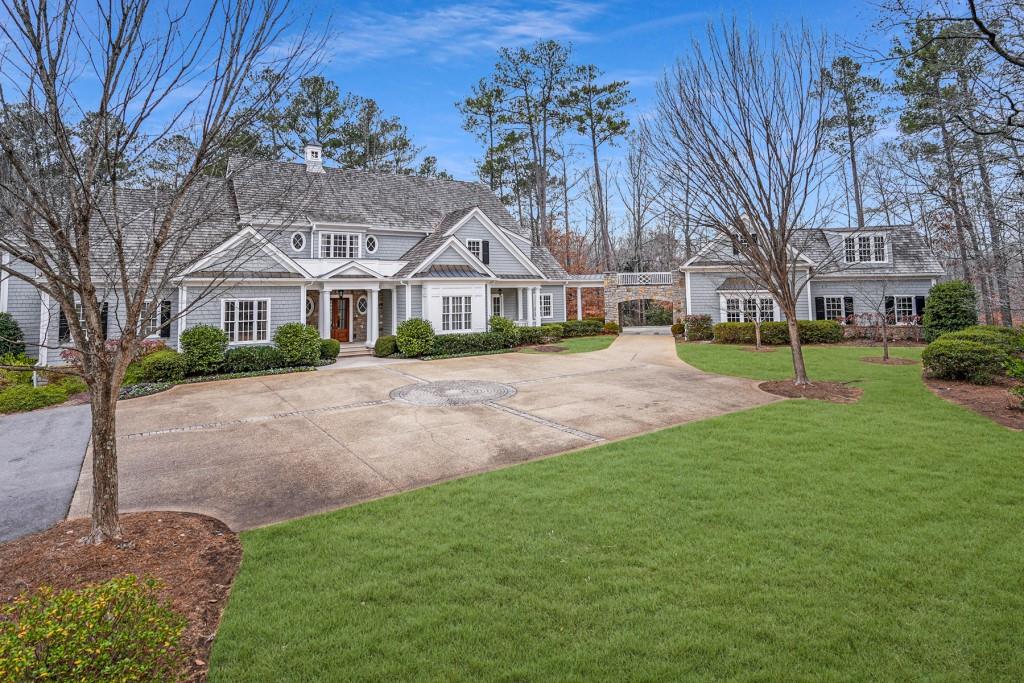 Sitting on 4+/- acres of beautifully manicured, super private property, this elegant Spitzmiller & Norris traditional New England style home exudes an abundance of dignity and charm. Built in 2002 by Phillip Clark Custom Builders, the homes open floor plan is perfect for entertaining with French doors leading to the fabulous bluestone patio and walkout level backyard from both the formal living room and large family room. A formal dining room with silver closet, light filled gourmet kitchen with breakfast area and sizeable butler's pantry are an entertainer's dream. Completing the main level is the handsome mahogany paneled library/office with fireplace and an owner's suite with separate marble his and her bathrooms and spacious custom closets. On the second level of the home are five large bedrooms, each with their own ensuite bathrooms. One of these bedrooms is currently being used as a large office space with two workstations. The terrace level is also an entertainer's delight with a gaming area, gorgeous custom wine cellar and tasting room, large movie theater with updated electronics, gym, one additional bedroom and bathroom and plenty of great storage area. There is an elevator to all three levels of the home. The fully fenced grounds of the property are equally as lovely as the interior. Great level yard & beautiful gardens surround the home. The property is well prepared for weather emergencies being served by a whole-house generator. Located in close proximity to Buckhead, Sandy Springs & Chastain Park, all the local public & private schools & the best shopping & restaurants these areas have to offer. There is no doubt about it - this home is perfect for the buyer who wants supreme privacy along with modern convenience. Welcome HOME!